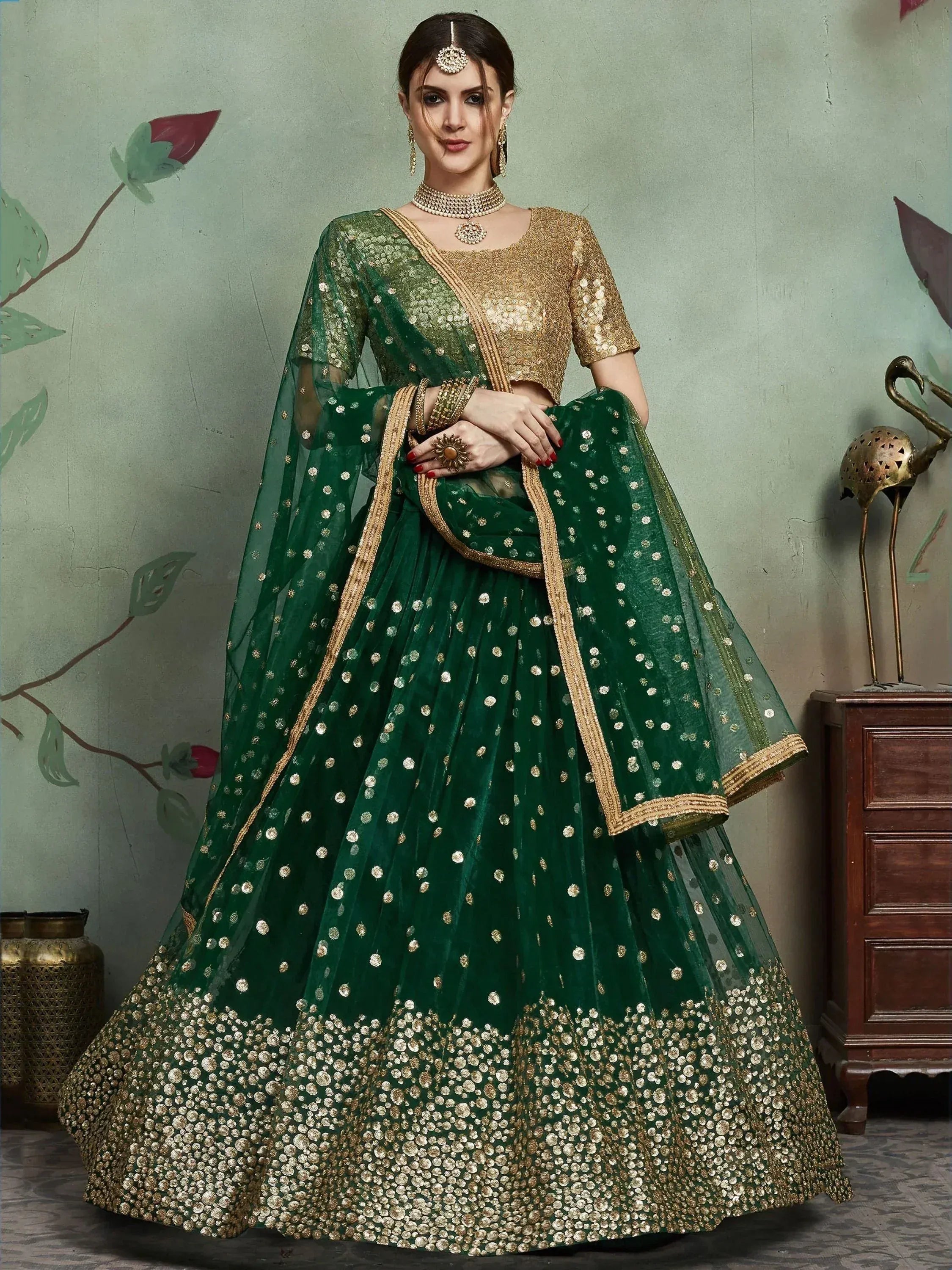 Emerald green lehenga choli with gold embroidery, perfect for Indian weddings and festive occasions.