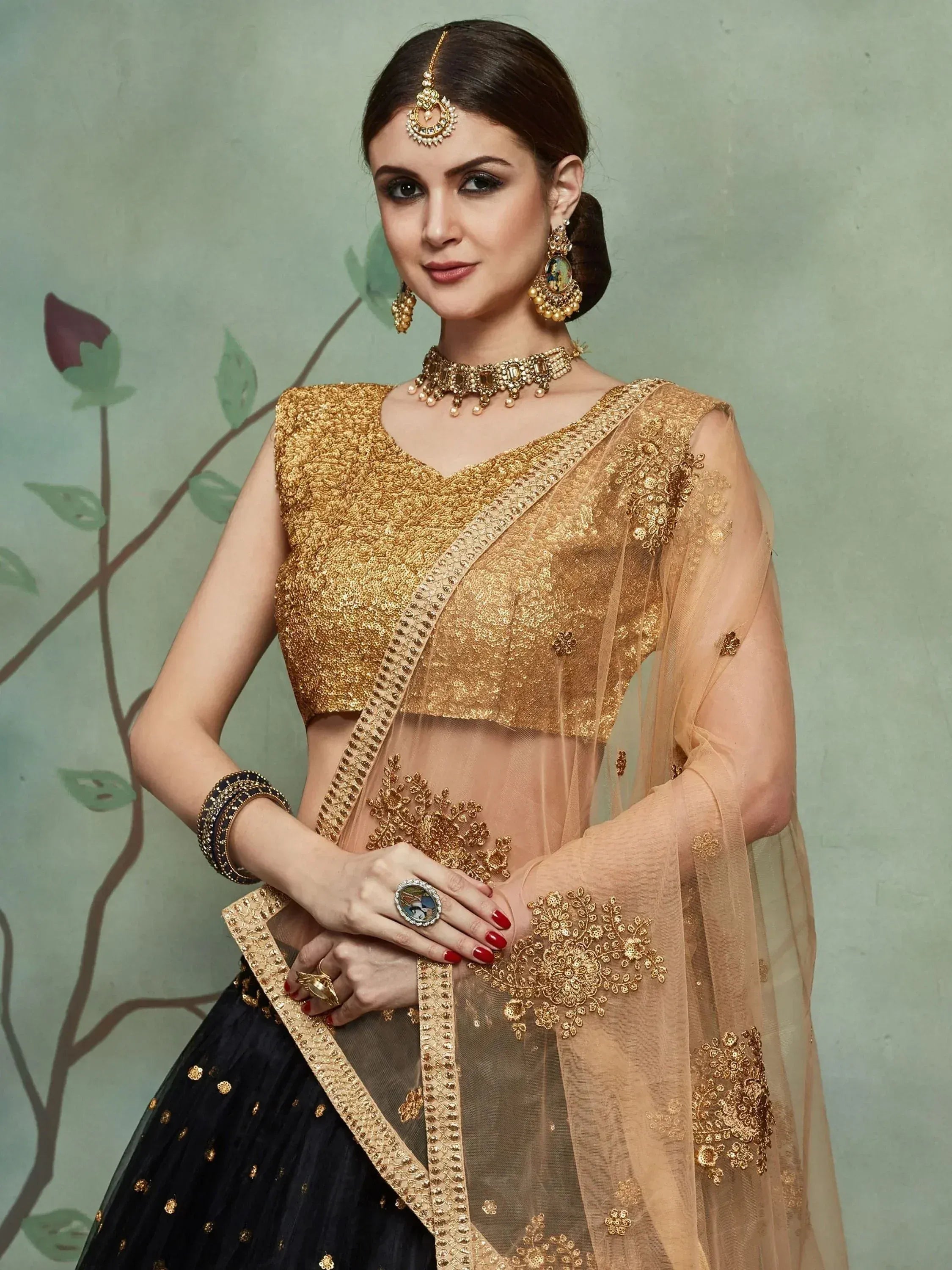 Golden embroidered lehenga choli with sheer dupatta, traditional Indian ethnic wear for weddings and festivals