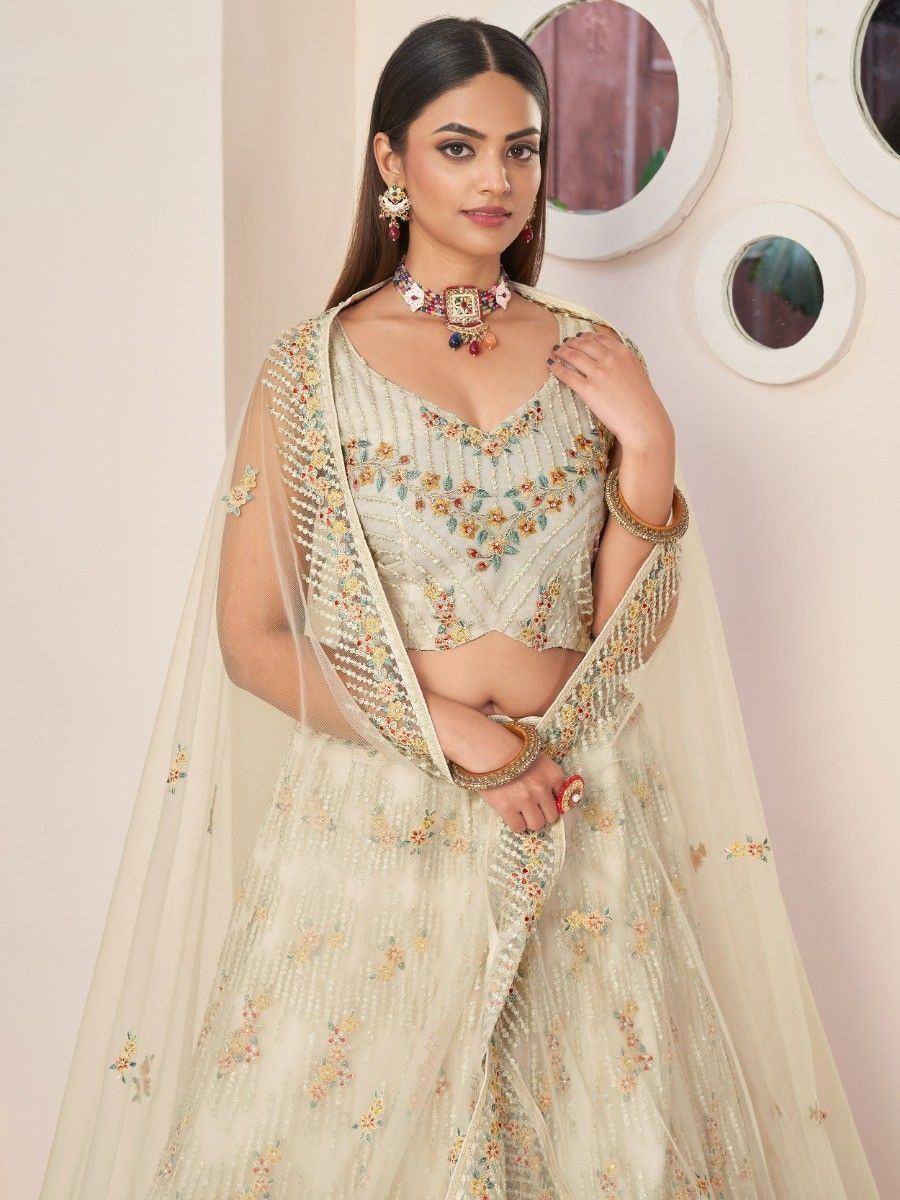 Cream floral embroidered lehenga choli with sheer dupatta, perfect for Indian weddings and festive occasions
