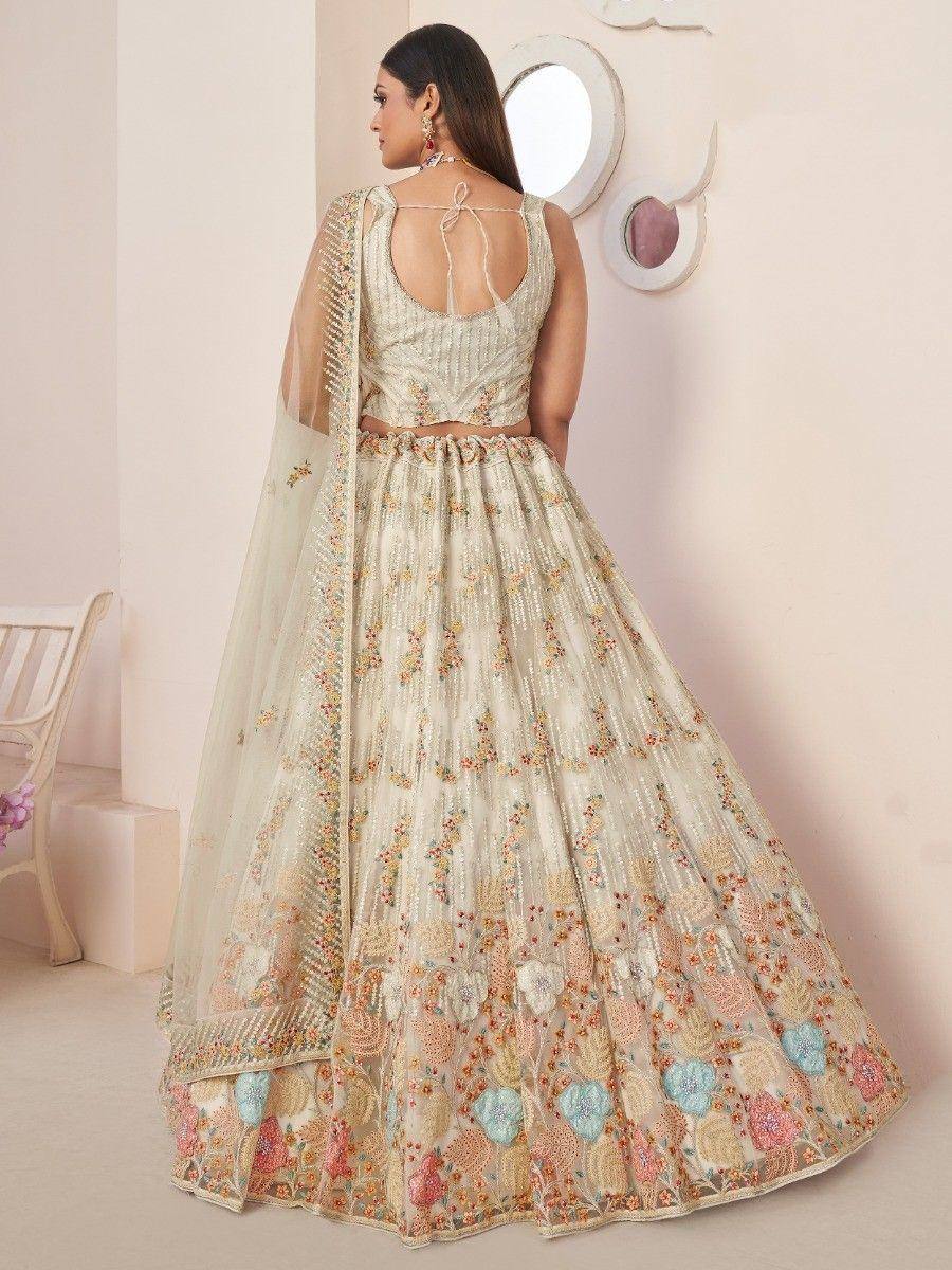 Elegant cream lehenga choli with floral embroidery and sheer dupatta, perfect for Indian weddings or festive occasions.