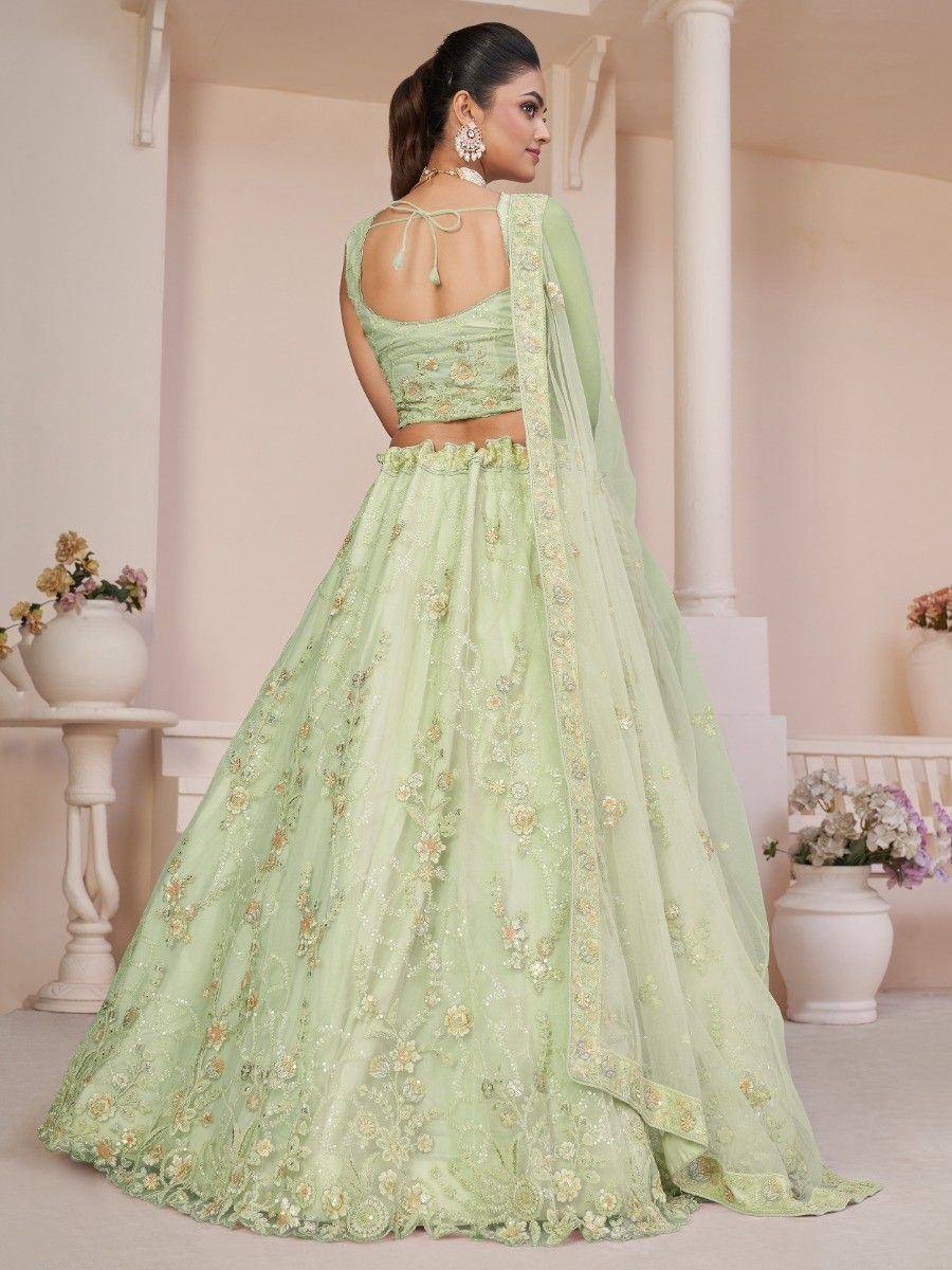 Mint green designer lehenga choli with floral embroidery and sheer dupatta, perfect for weddings and festive occasions.