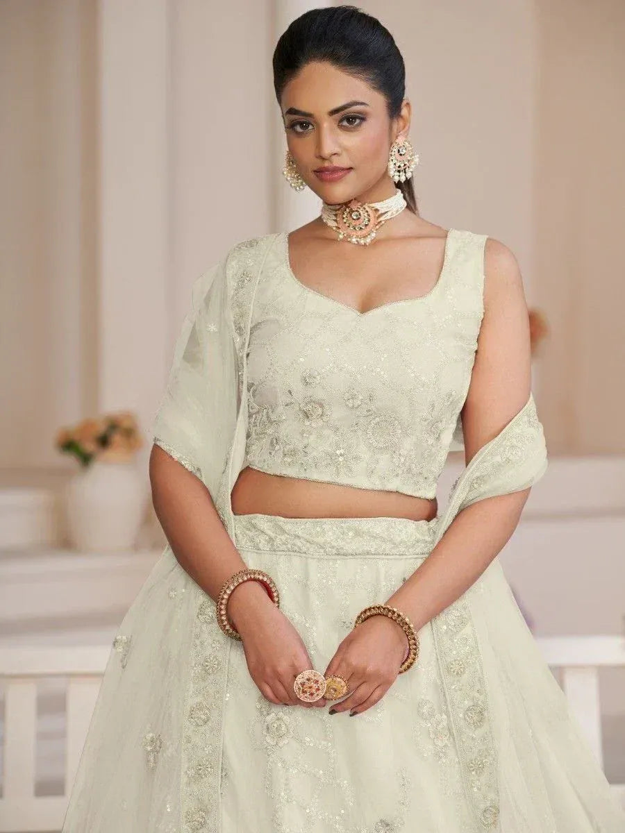 Elegant off-white embroidered lehenga choli with matching dupatta, perfect for Indian weddings and festive occasions.