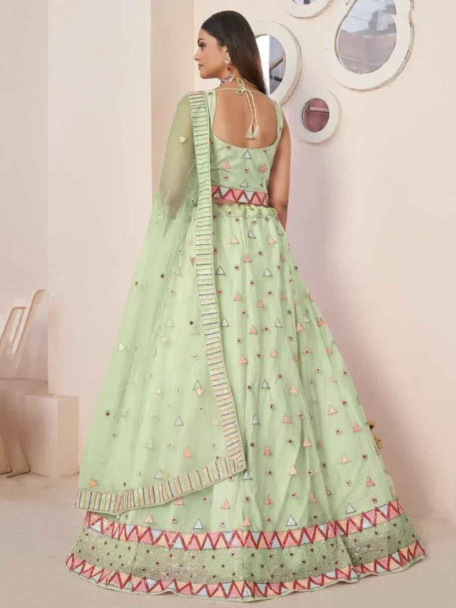 Mint green lehenga choli with geometric embroidery and pink border, perfect for Indian ethnic wear occasions