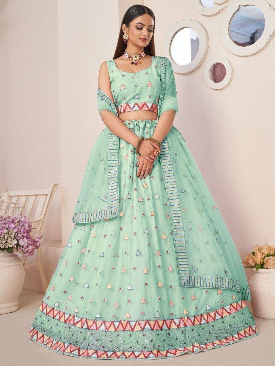 Mint green designer lehenga choli with geometric embroidery and colorful border, perfect for Indian ethnic occasions