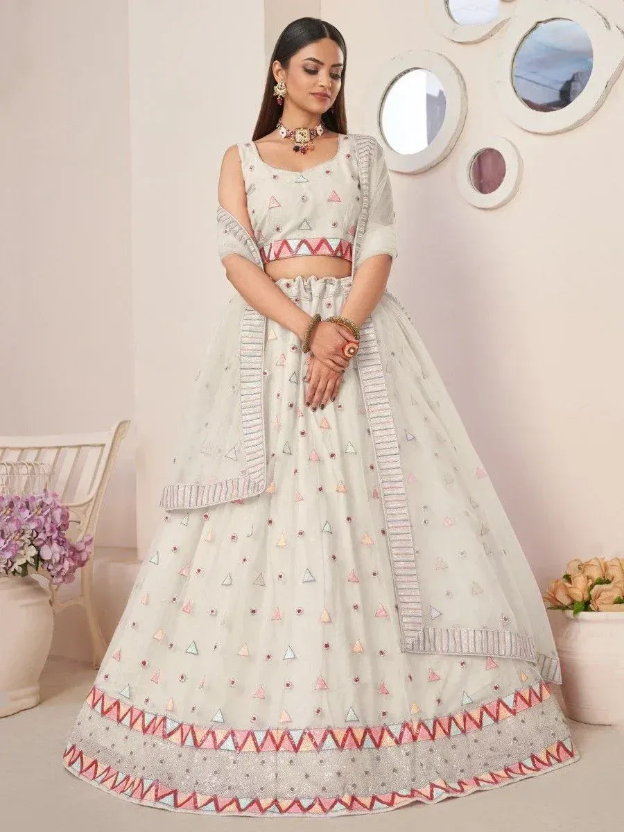 White embroidered lehenga choli with geometric patterns, perfect for Indian ethnic wear and festive occasions.