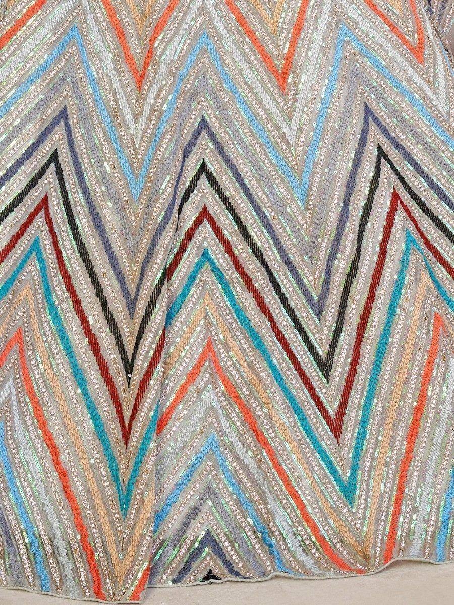 Colorful zigzag sequin embroidery on ethnic wear fabric, perfect for lehenga choli or saree designs