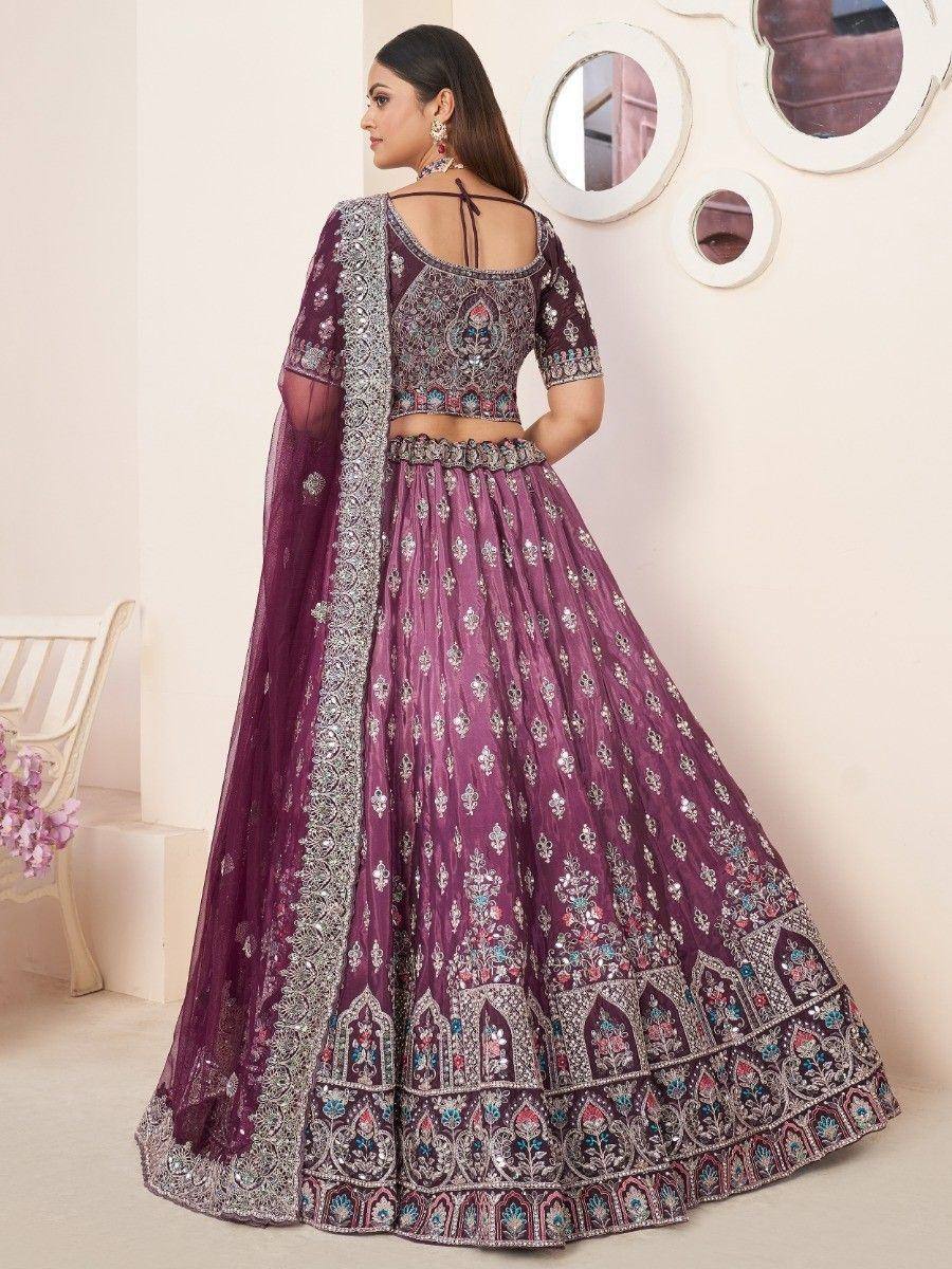 Purple embroidered lehenga choli with detailed back design and matching dupatta, ideal for Indian weddings and festive occasions.