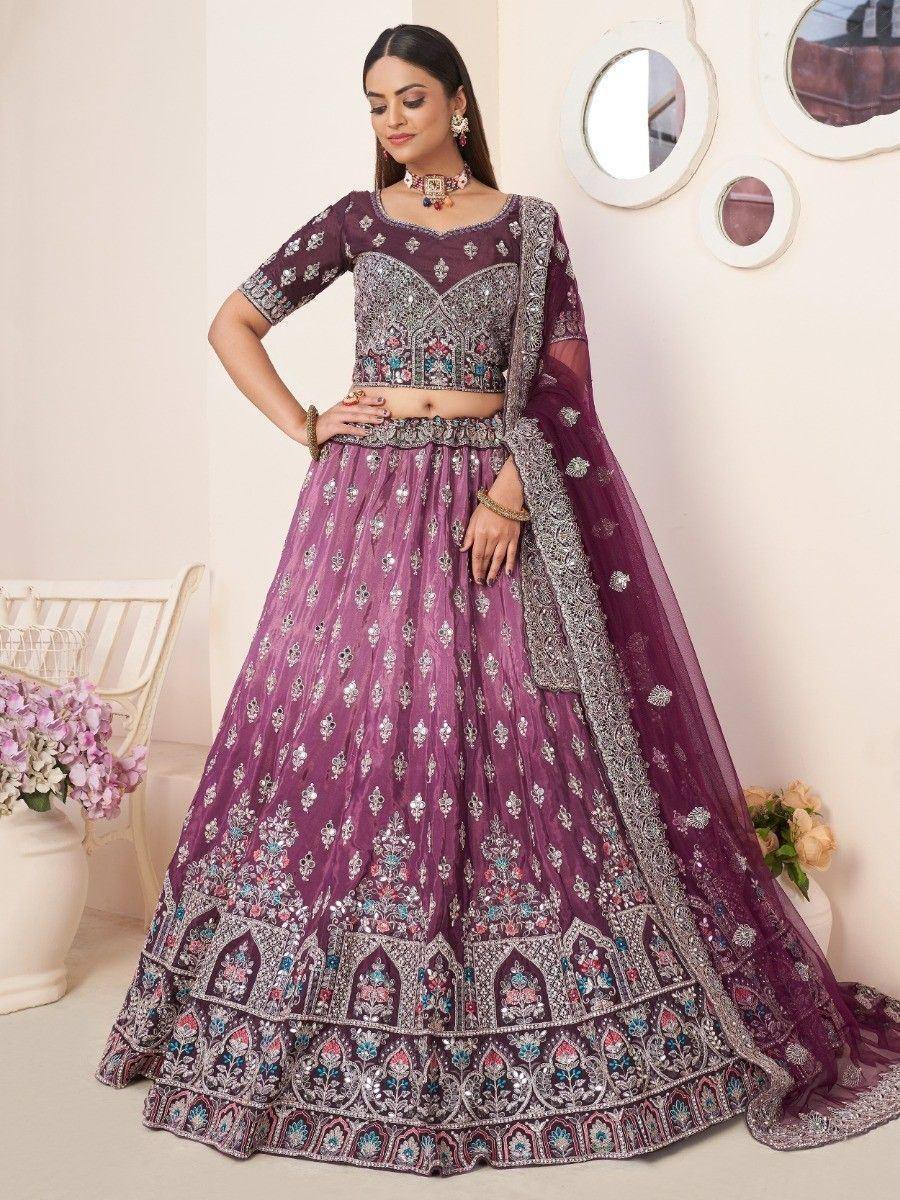 Purple embroidered lehenga choli with heavy embellishments, perfect for Indian weddings and festive occasions.