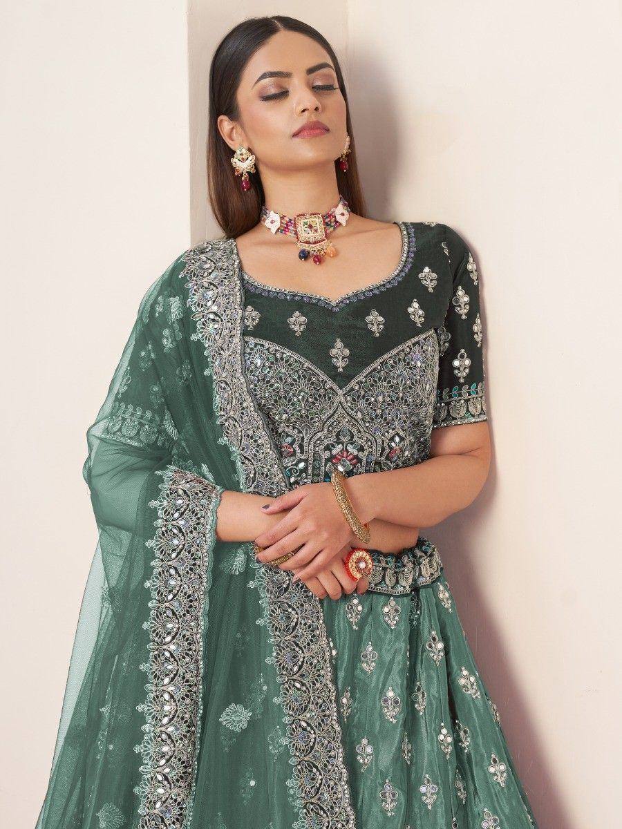 Emerald green designer lehenga choli with heavy silver embroidery and matching dupatta, perfect for weddings and festive occasions.