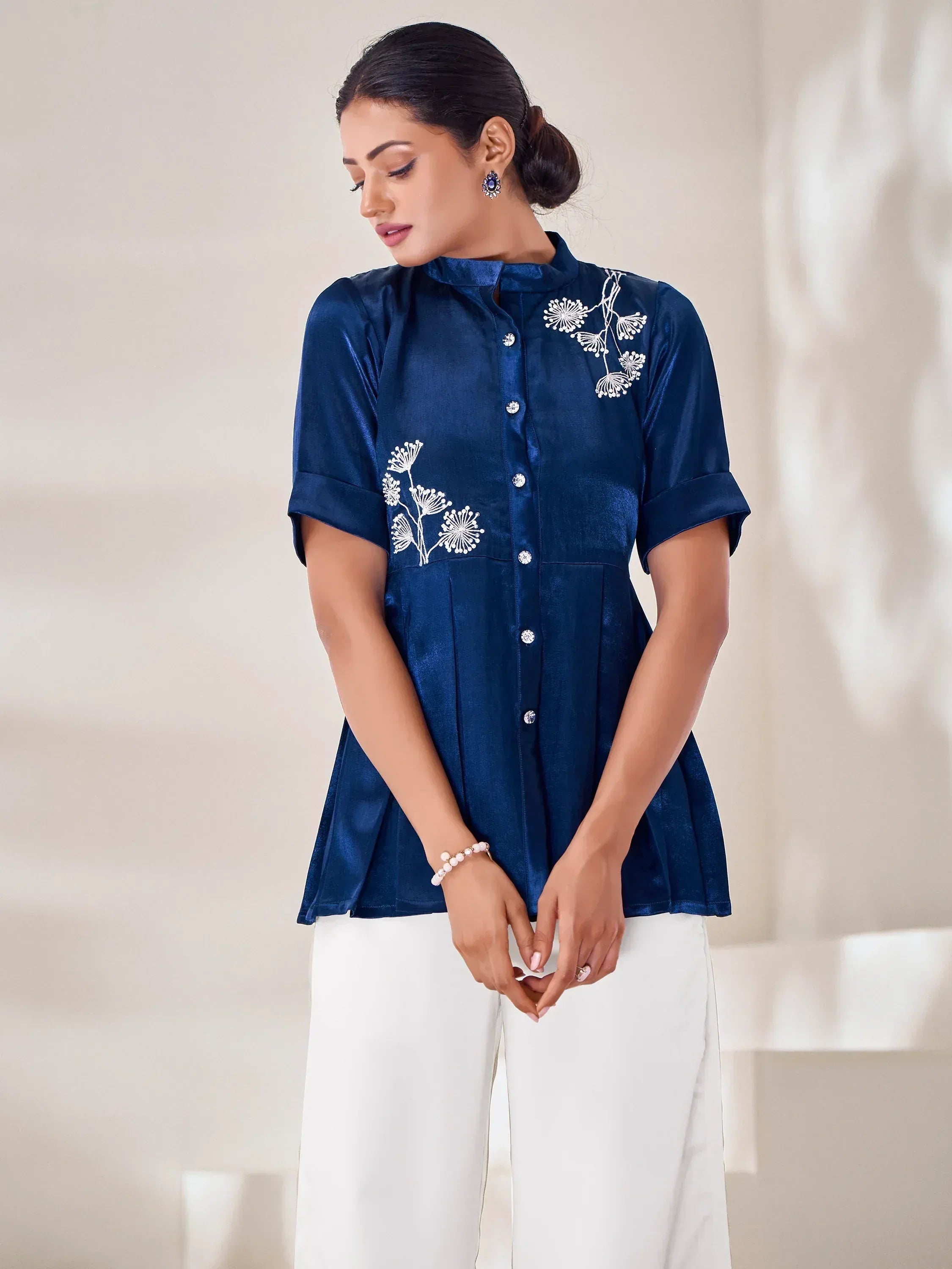 Navy blue embroidered kurta with floral design, paired with white pants for ethnic wear