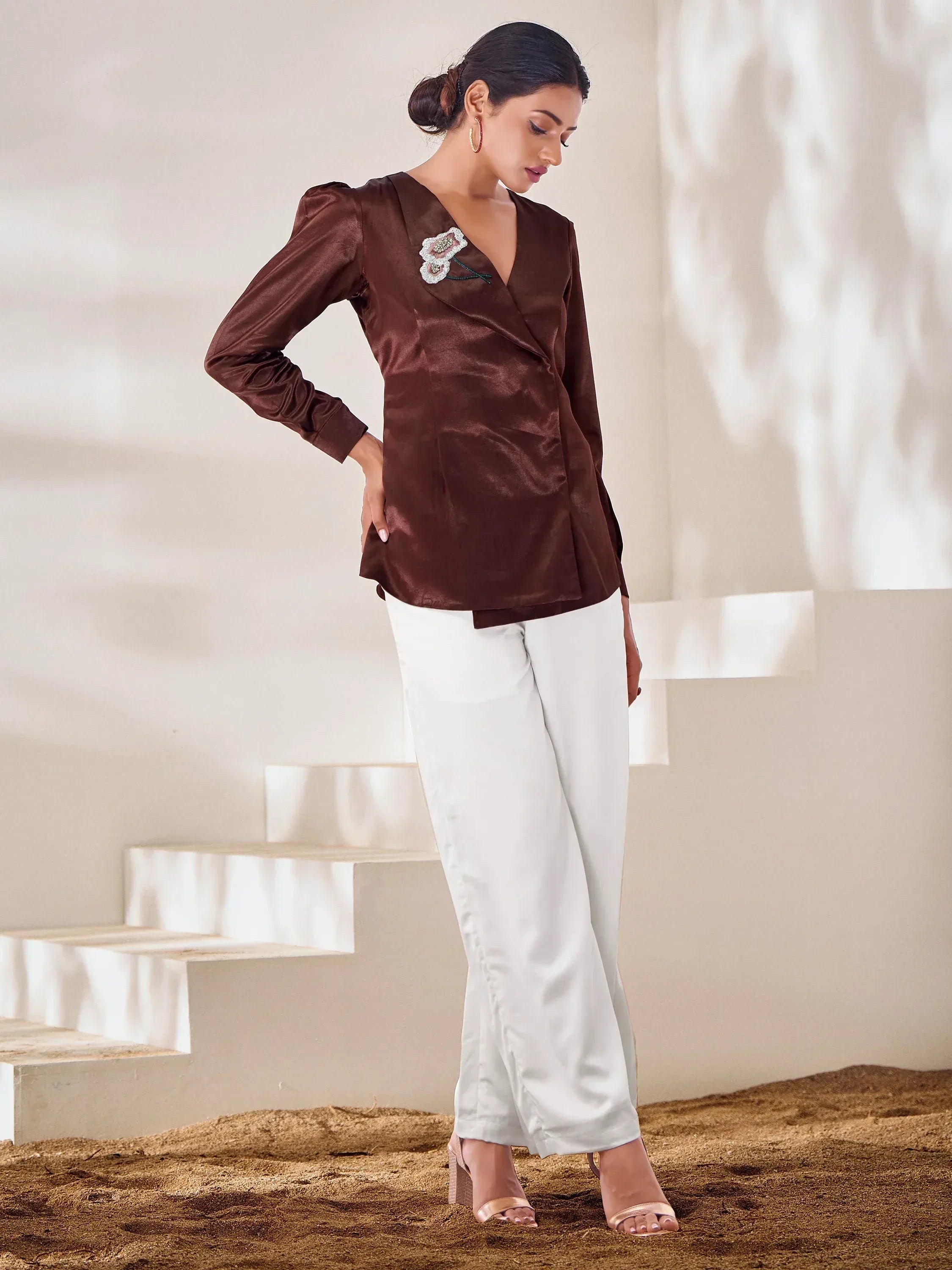 Brown satin wrap top with floral embroidery paired with white palazzo pants, ethnic wear outfit