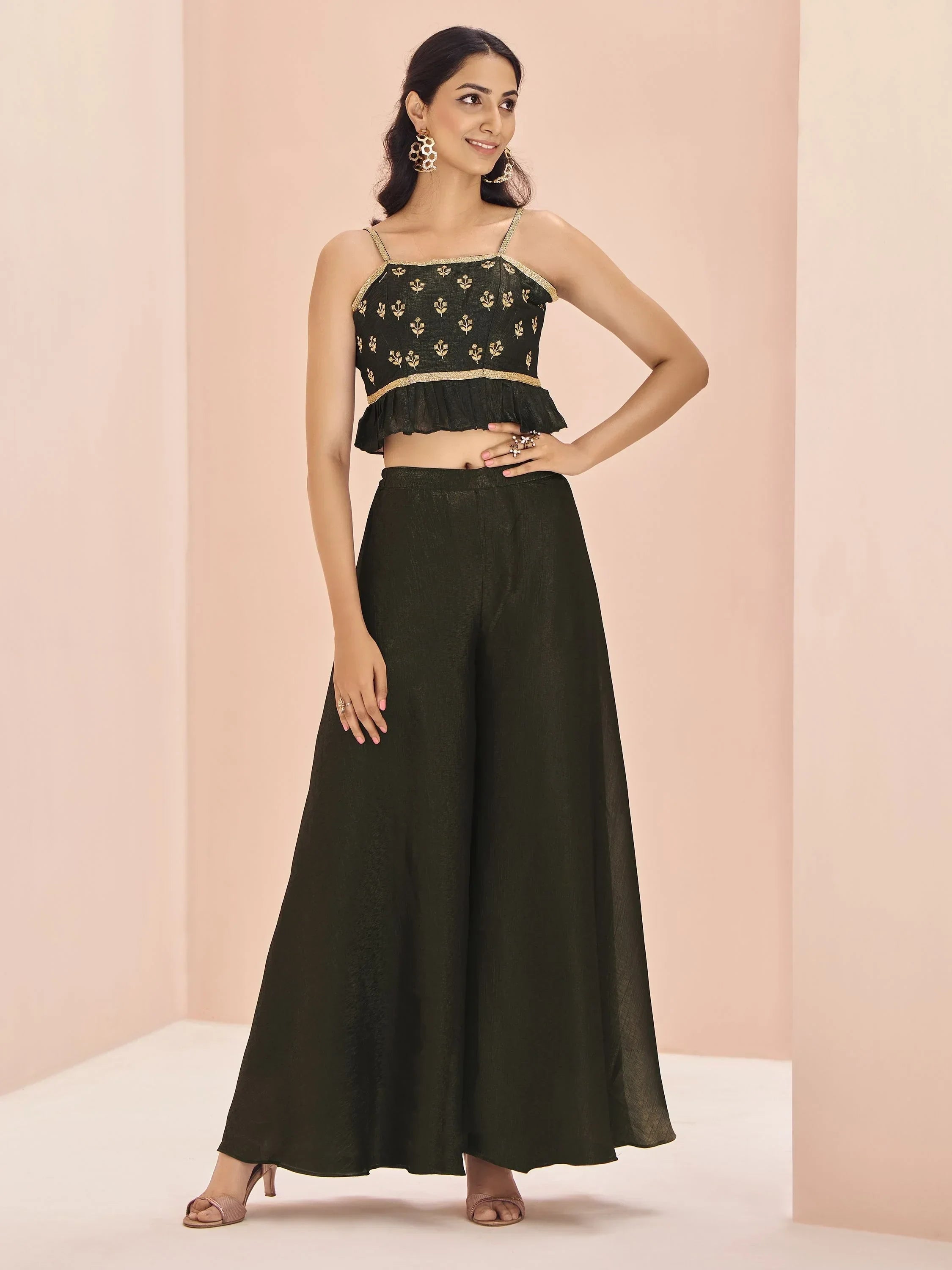 Woman in dark green ethnic crop top with gold embroidery and wide palazzo pants