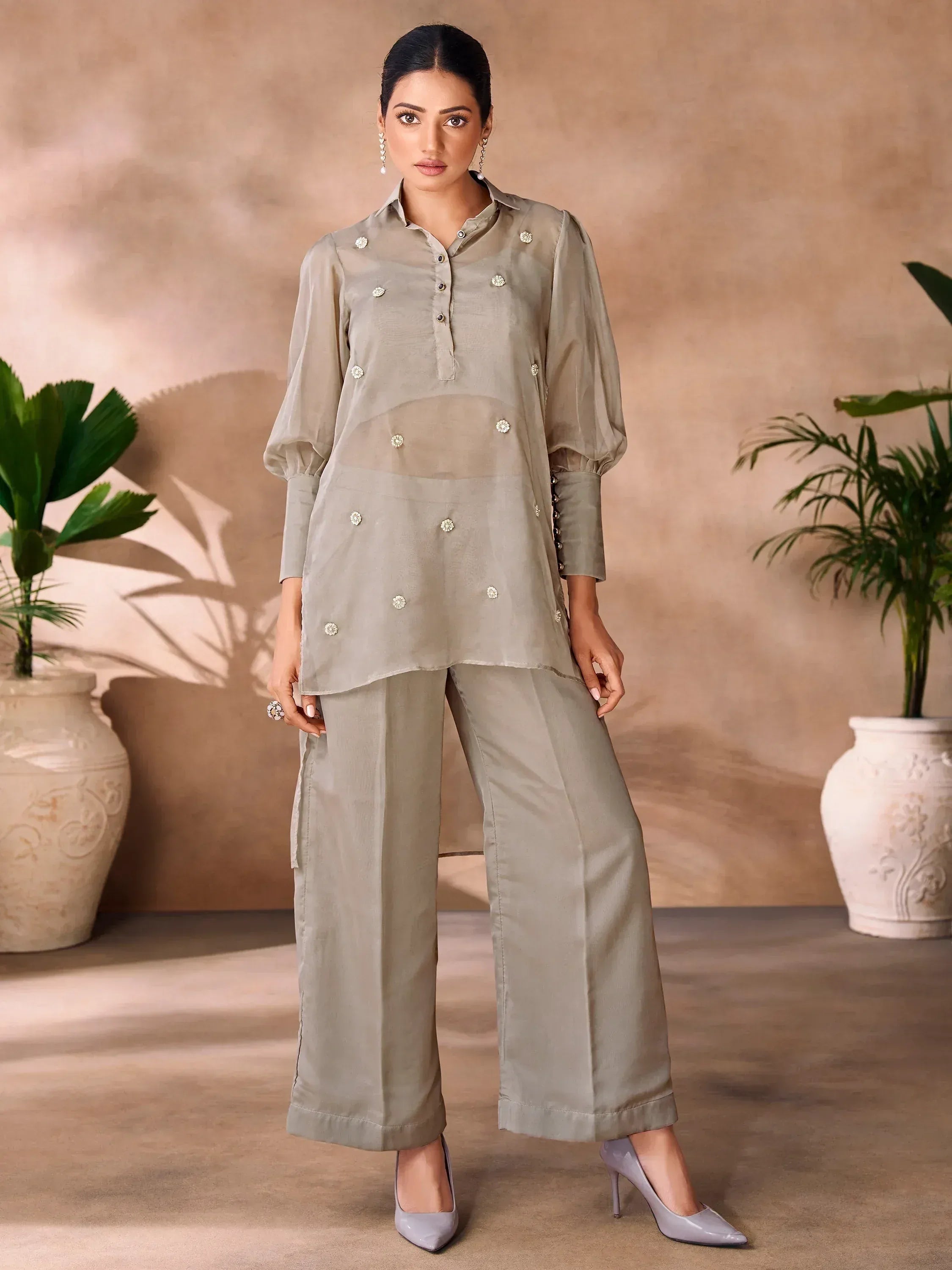 Stylish olive green salwar kameez with floral embellishments and wide-leg pants, perfect for ethnic wear.