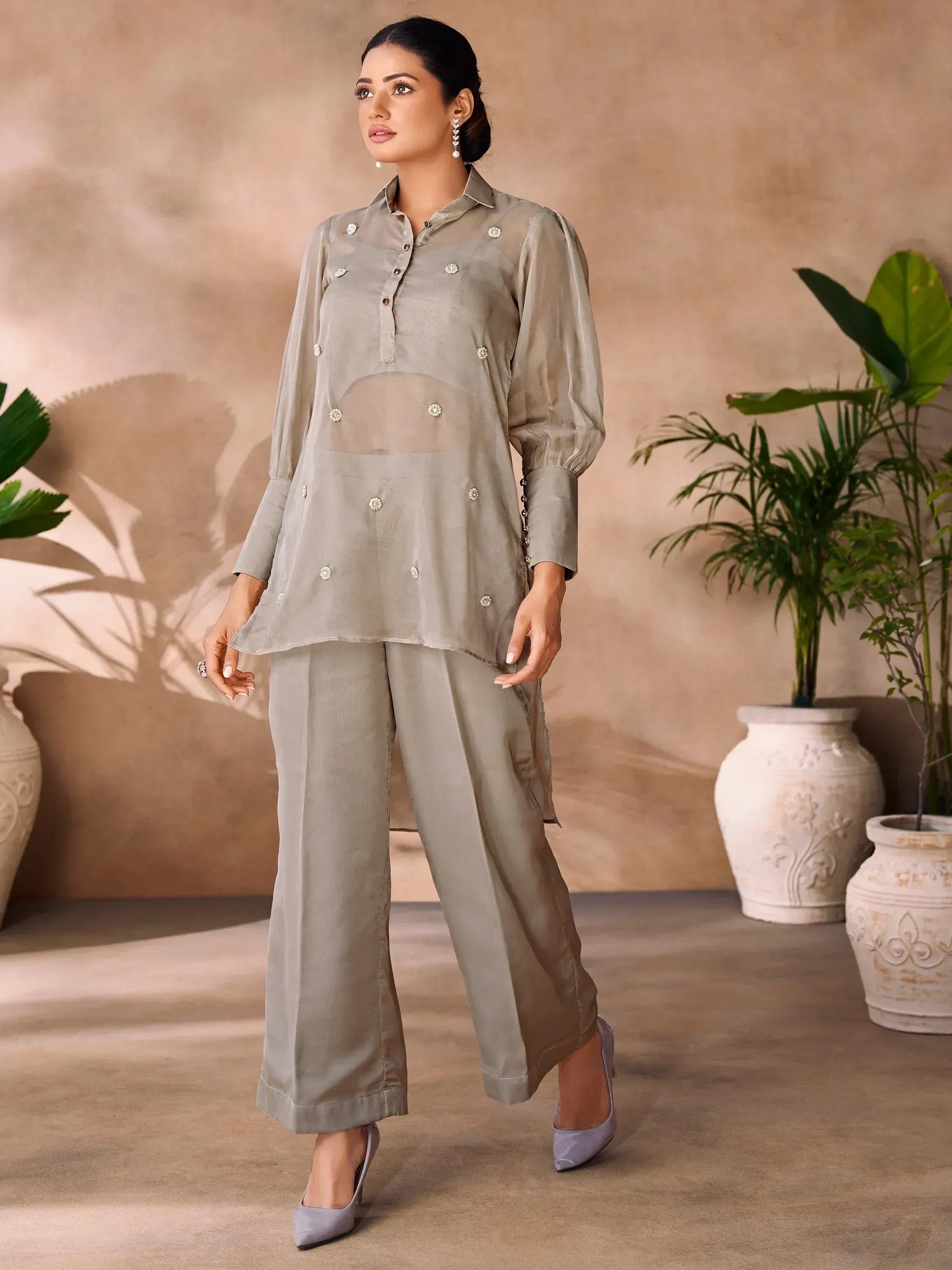 Stylish grey ethnic salwar kameez with embellished kurta and wide pants, perfect for modern Indian wear.