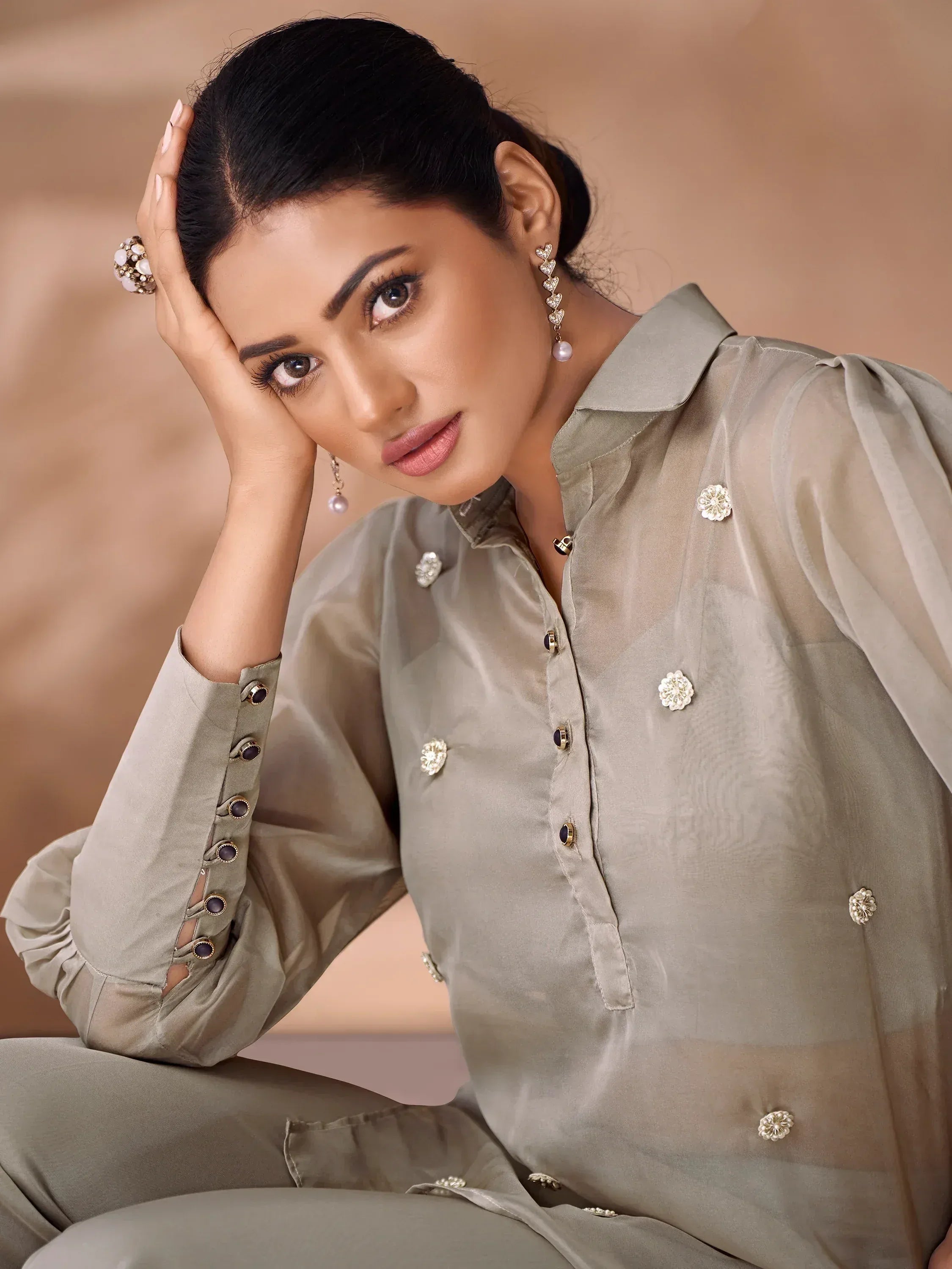Stylish olive green ethnic kurta with floral embellishments and puff sleeves, paired with matching pants for women.