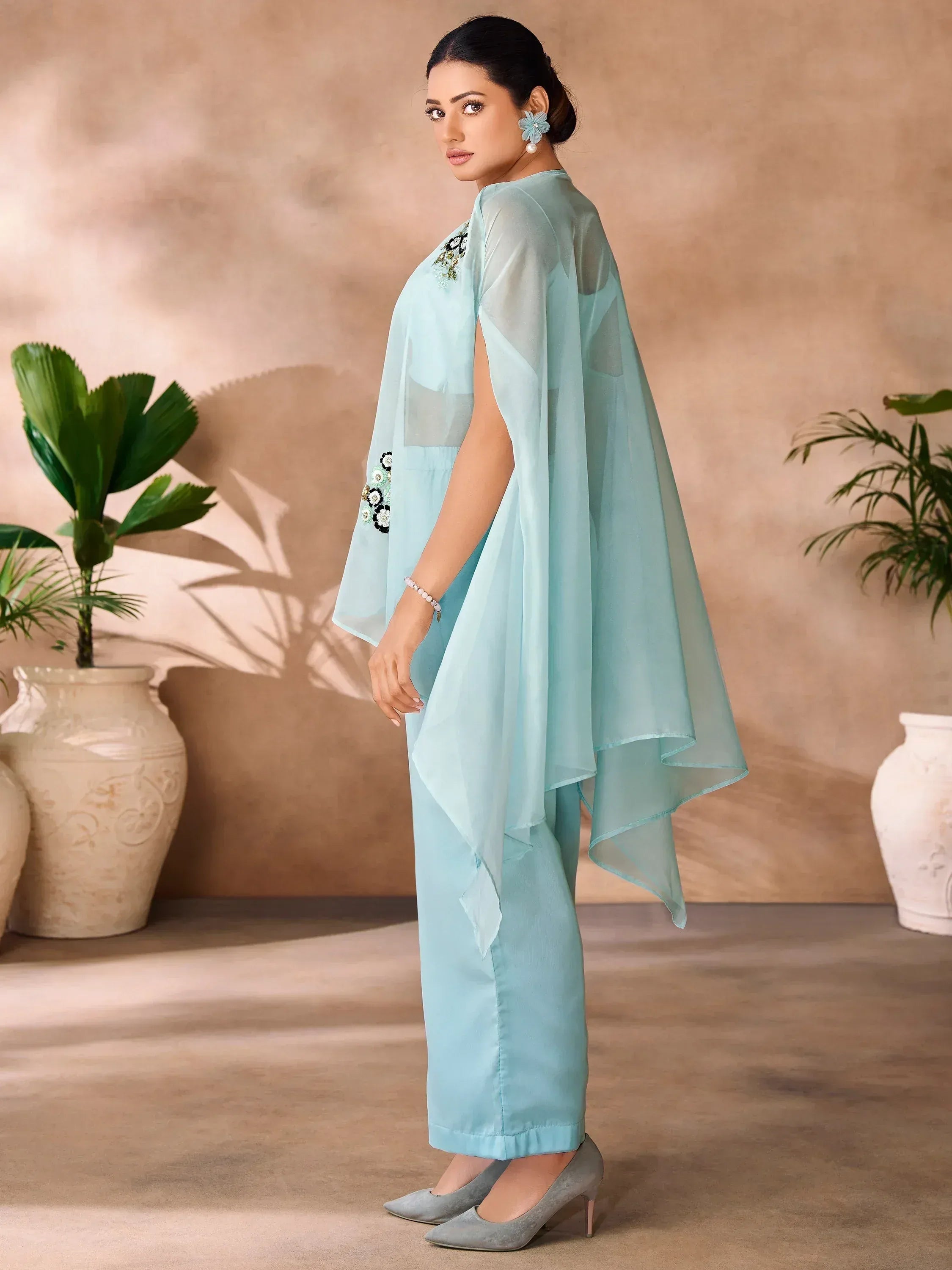 Light blue ethnic gown with floral embroidery and sheer cape, paired with palazzo pants for festive occasions