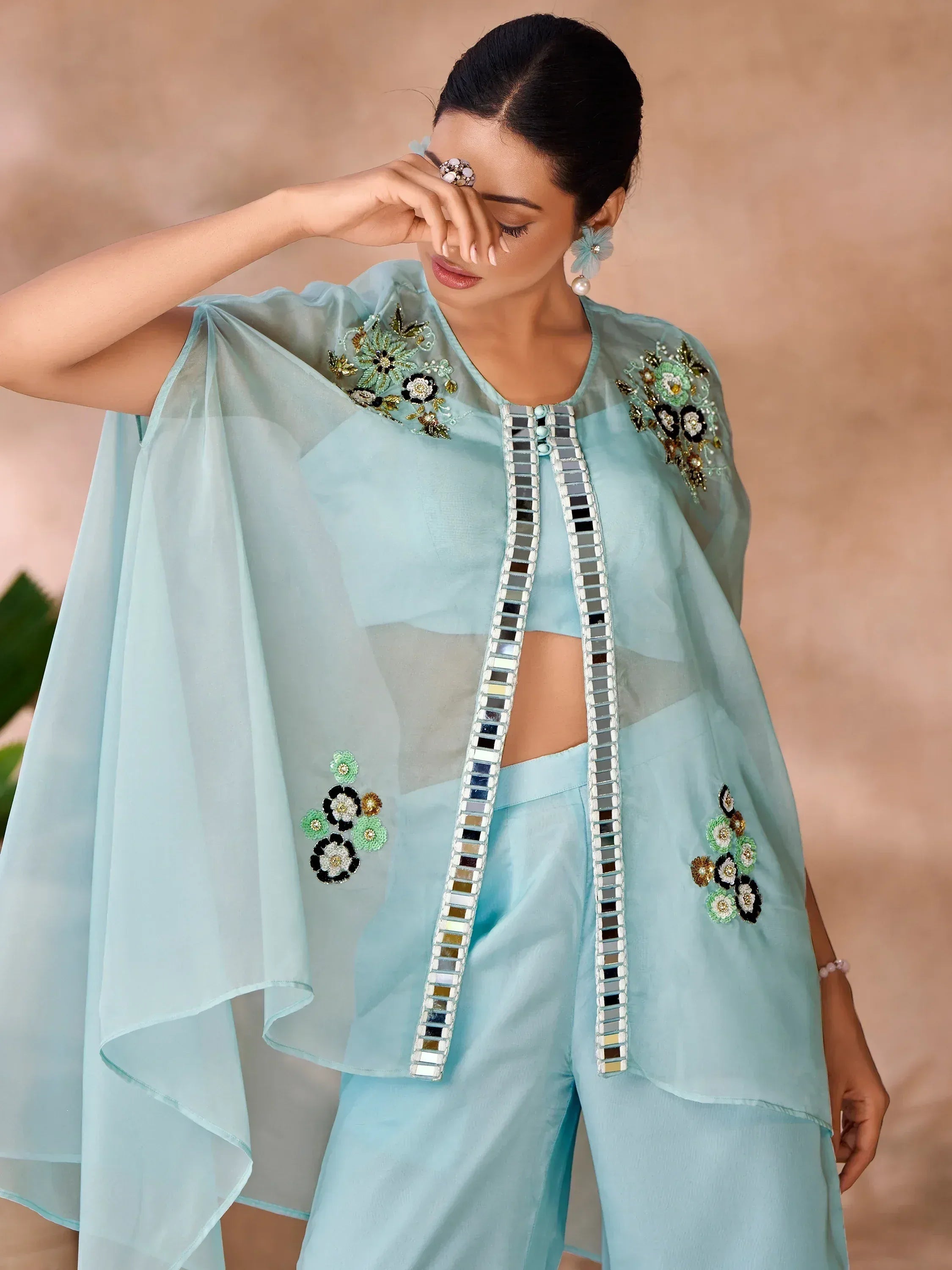 Light blue ethnic cape top with floral embroidery and mirror work, paired with matching palazzo pants
