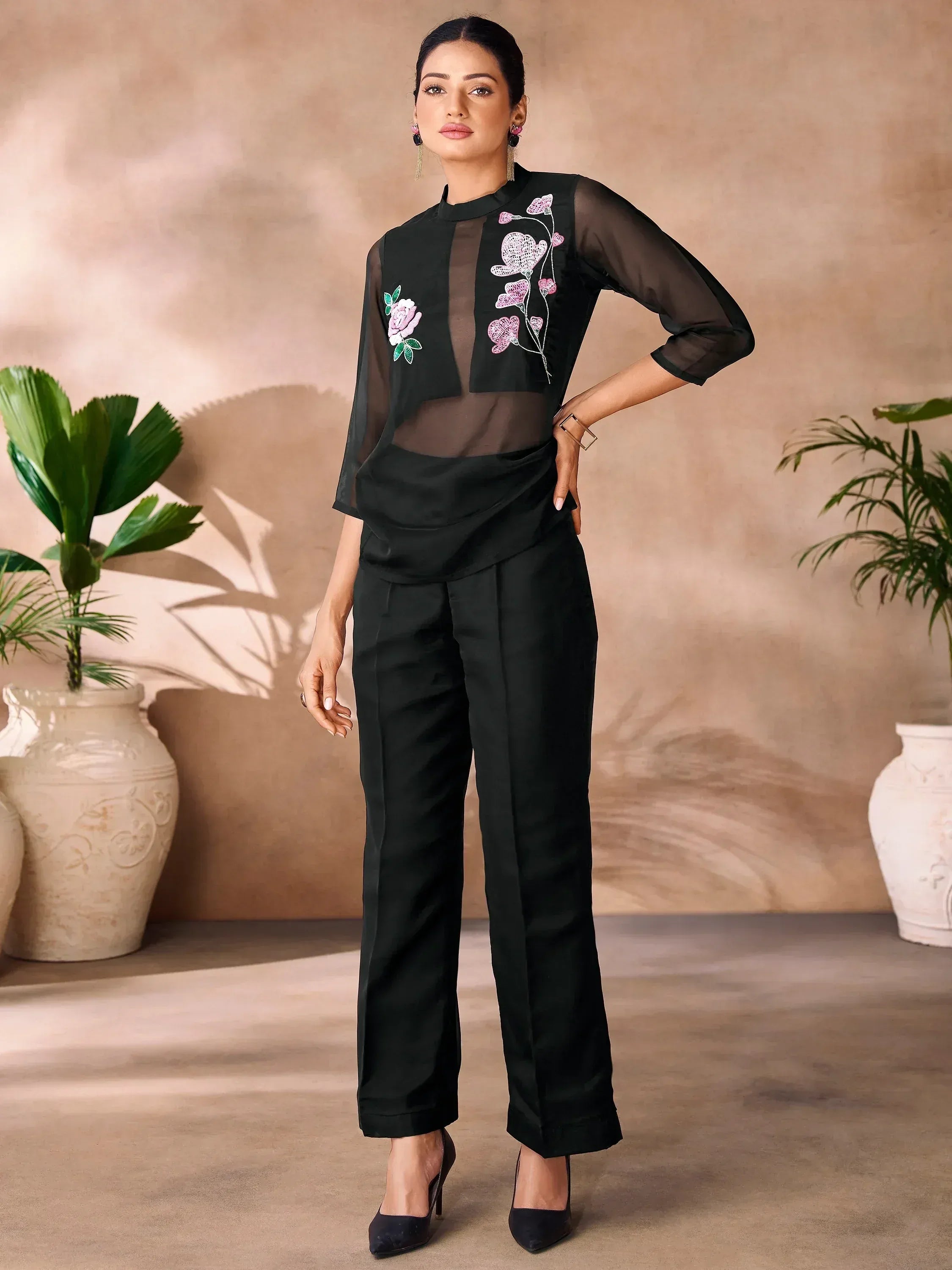 Black embroidered ethnic pantsuit with sheer sleeves and floral detailing, perfect for modern Indian wear.