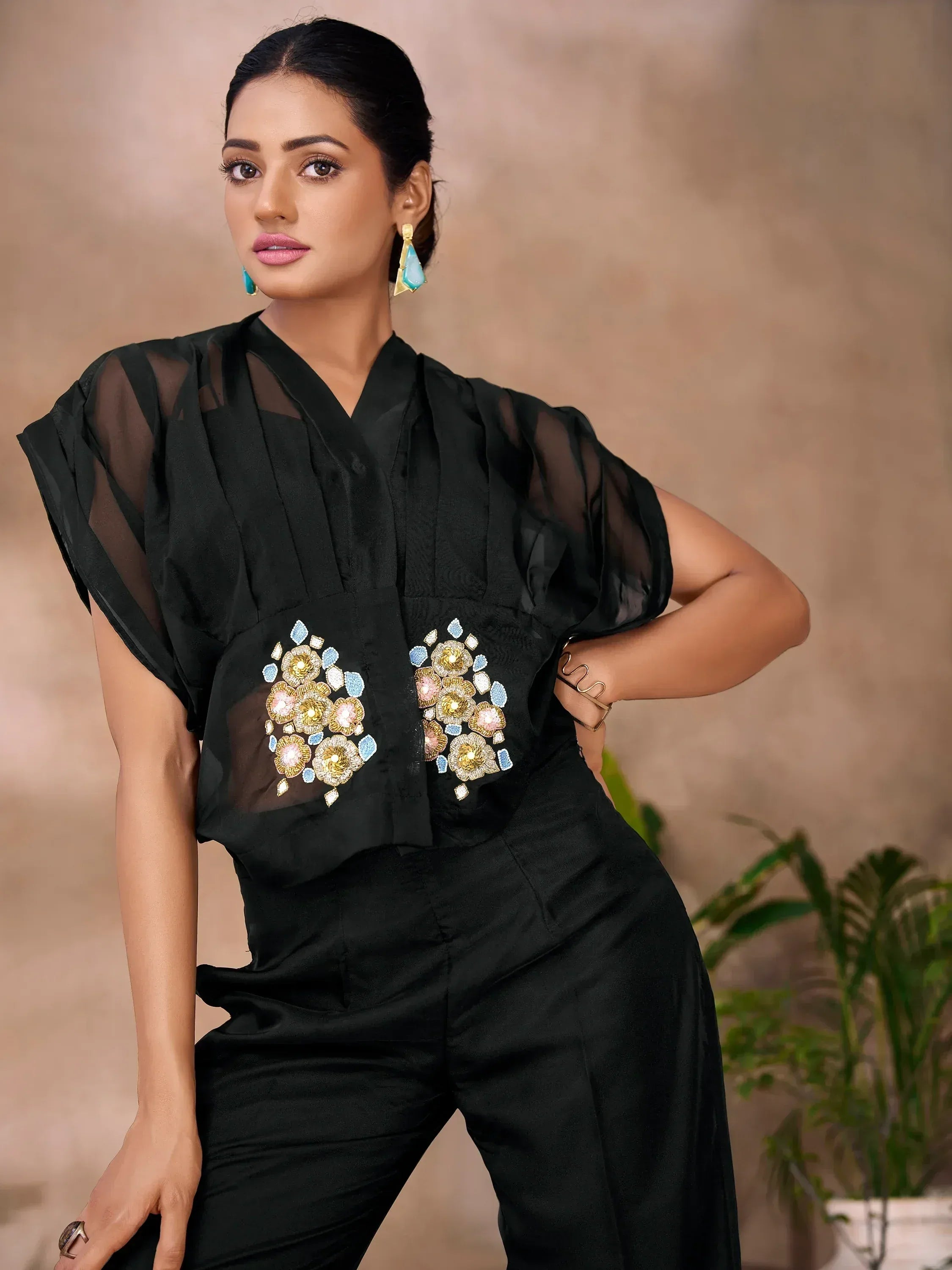 Black ethnic top with floral embroidery and sheer sleeves, paired with matching pants for modern Indian wear