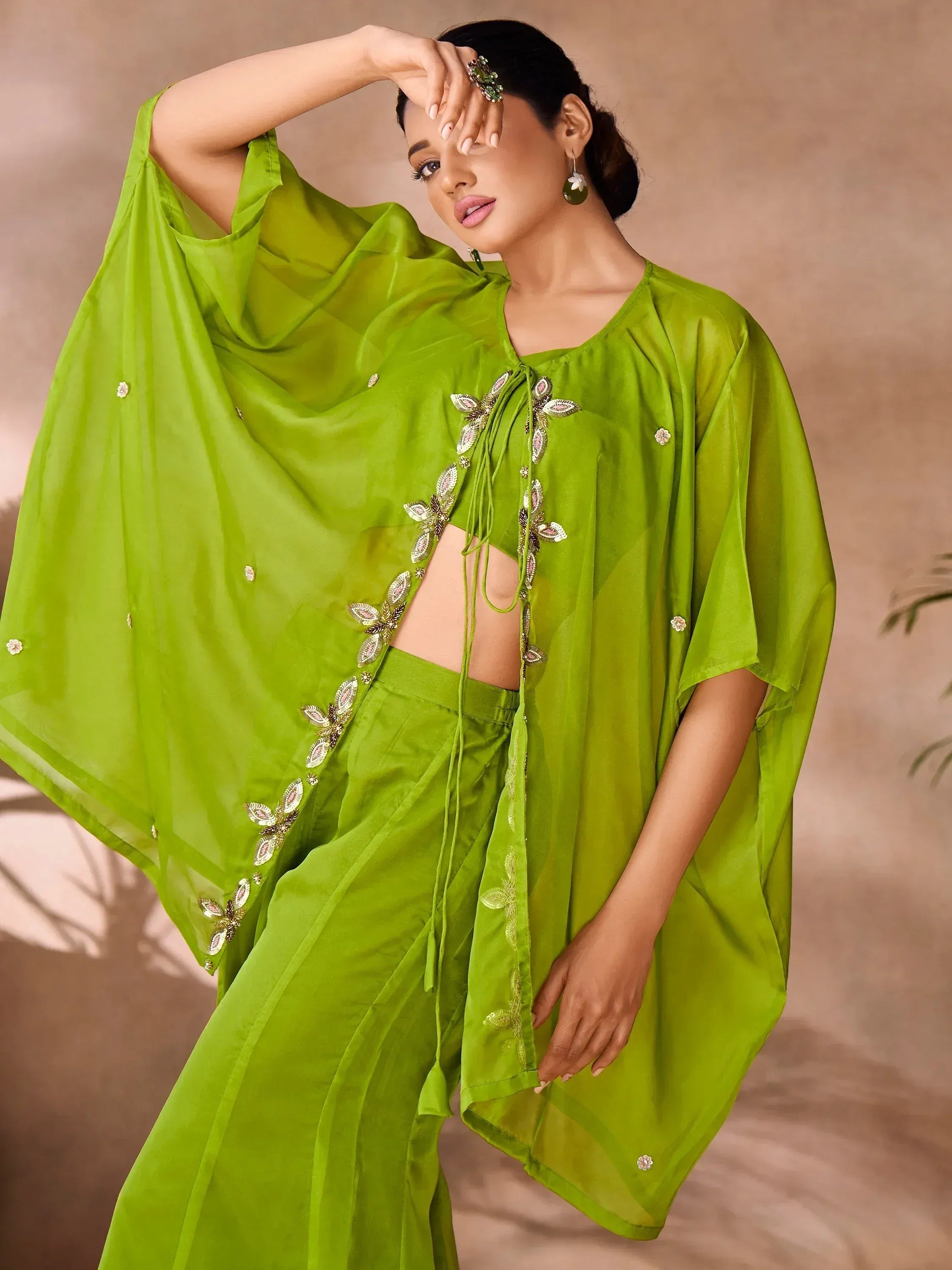 Vibrant green ethnic wear with floral embroidery, featuring a flowy top and palazzo pants for festive occasions.
