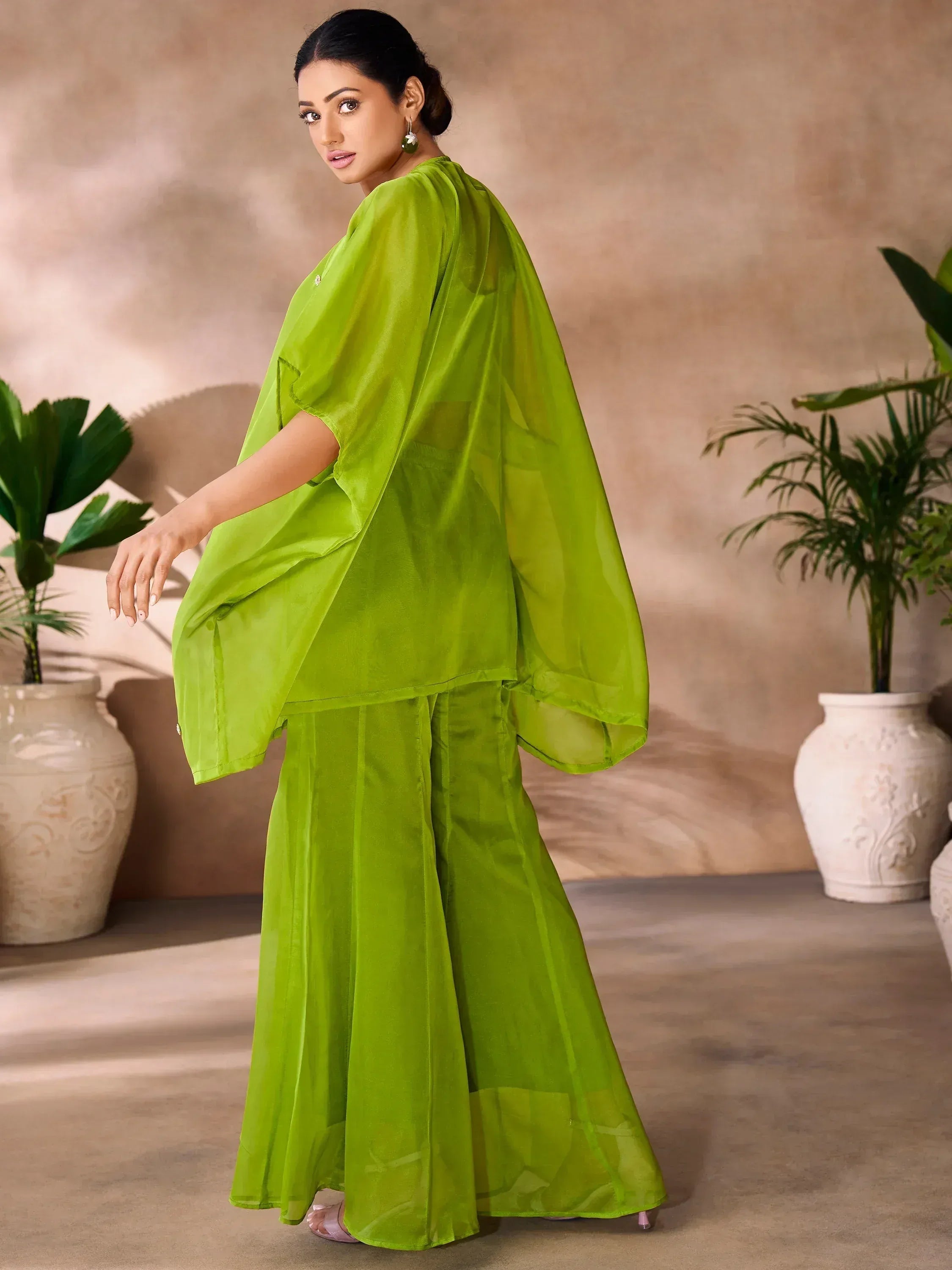 Vibrant green ethnic gown with flowing cape, perfect for Indian occasions and festive wear.