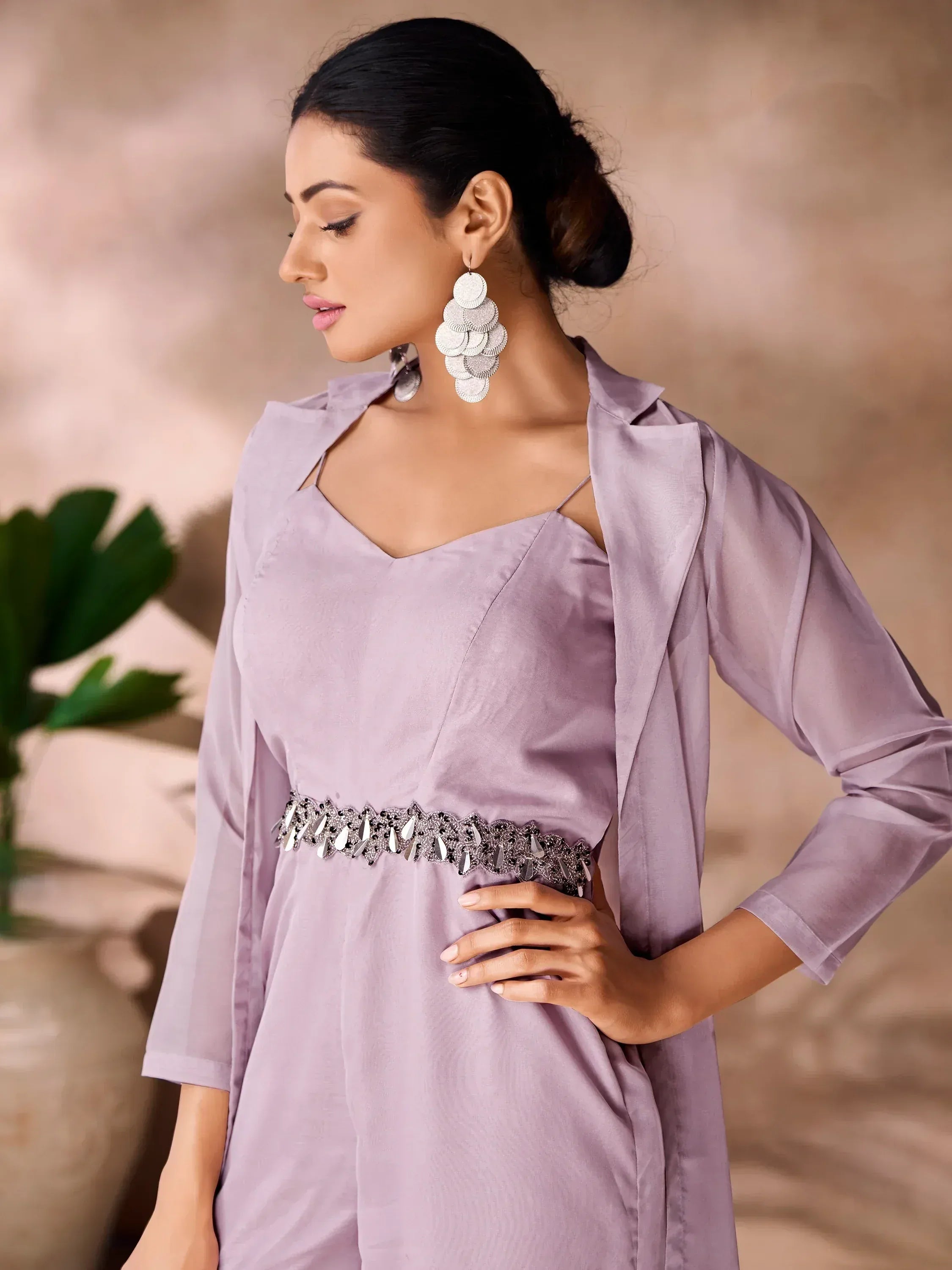 Lavender ethnic gown with embellished waistband and statement earrings, perfect for Indian occasions