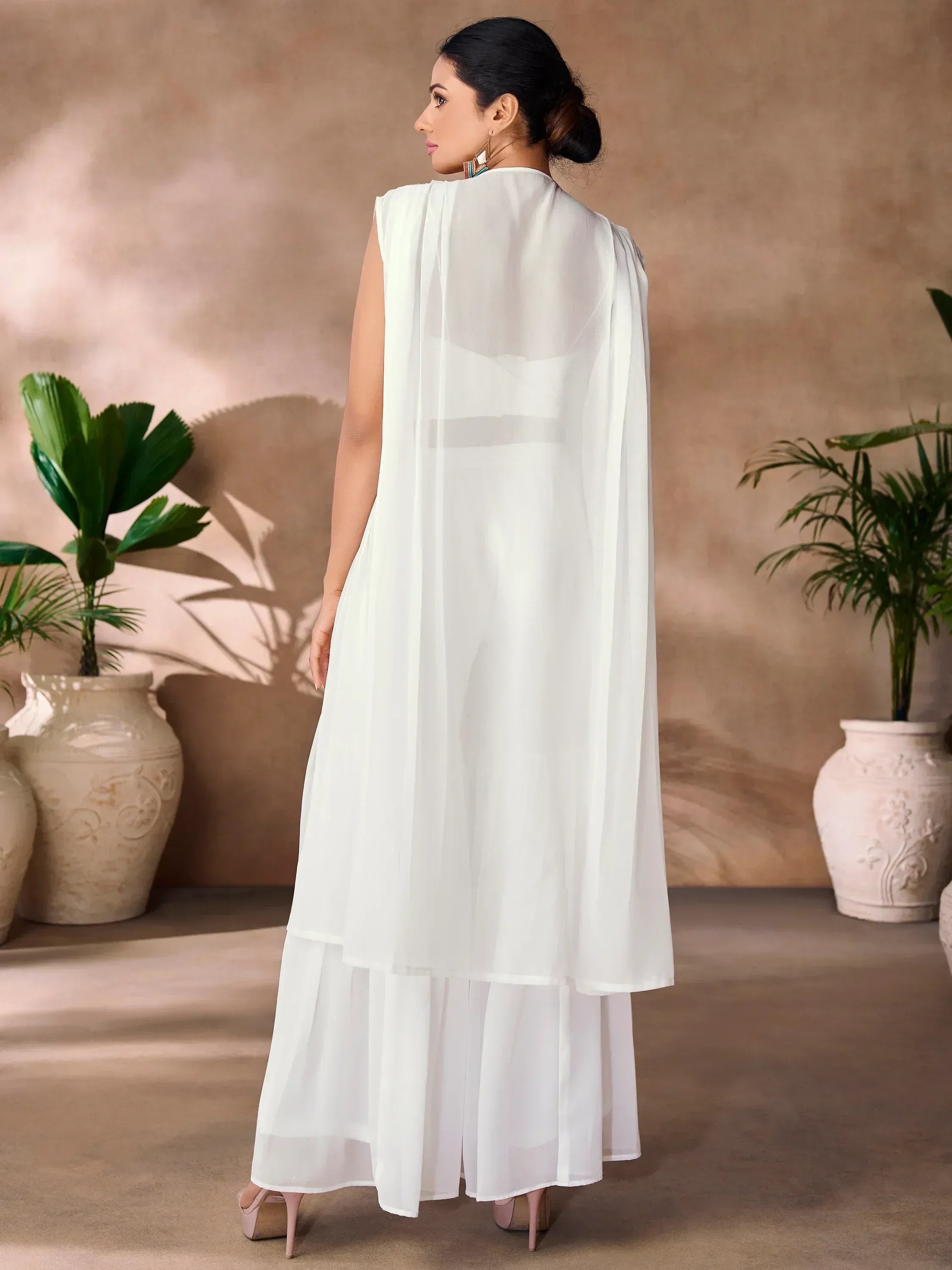White ethnic gown with cape back, layered skirt, and sheer fabric for Indian wear