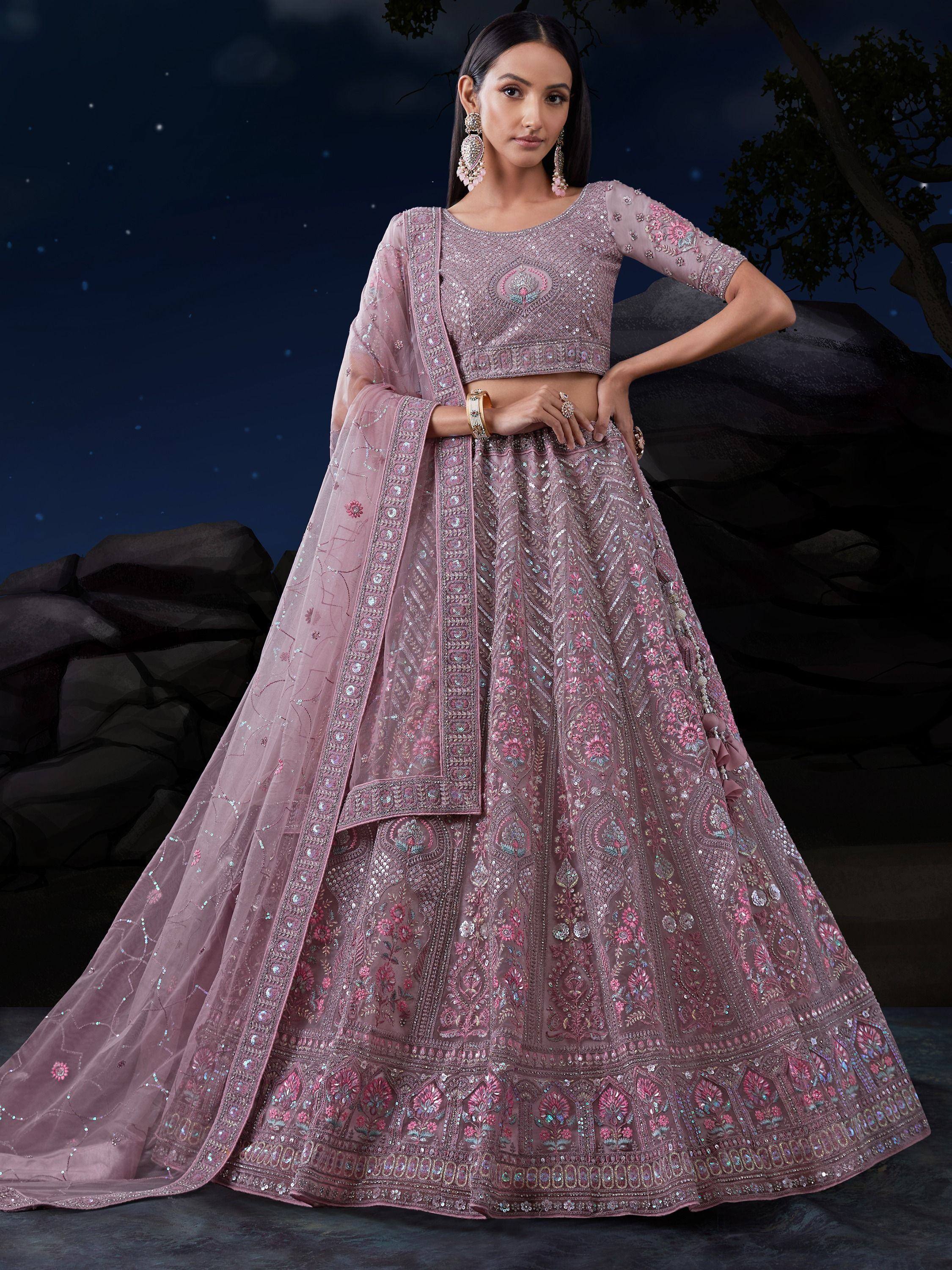 Elegant pink designer lehenga choli with intricate embroidery and sequins, perfect for weddings and festive occasions.