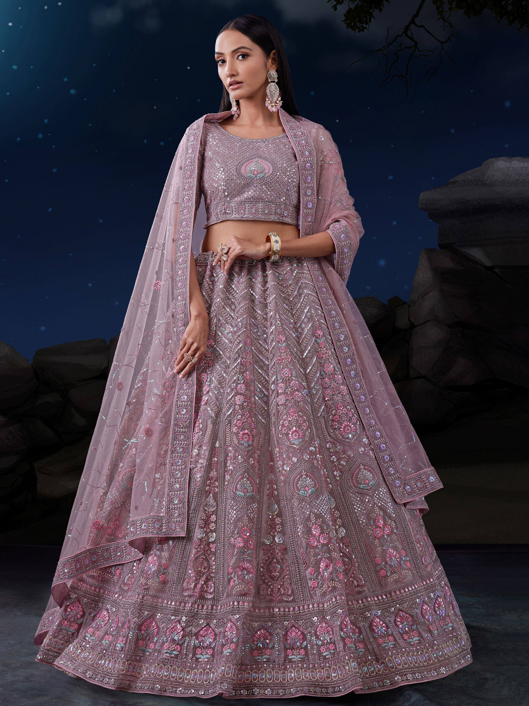 Elegant pink designer lehenga choli with intricate embroidery and sequins, perfect for weddings and festive occasions.
