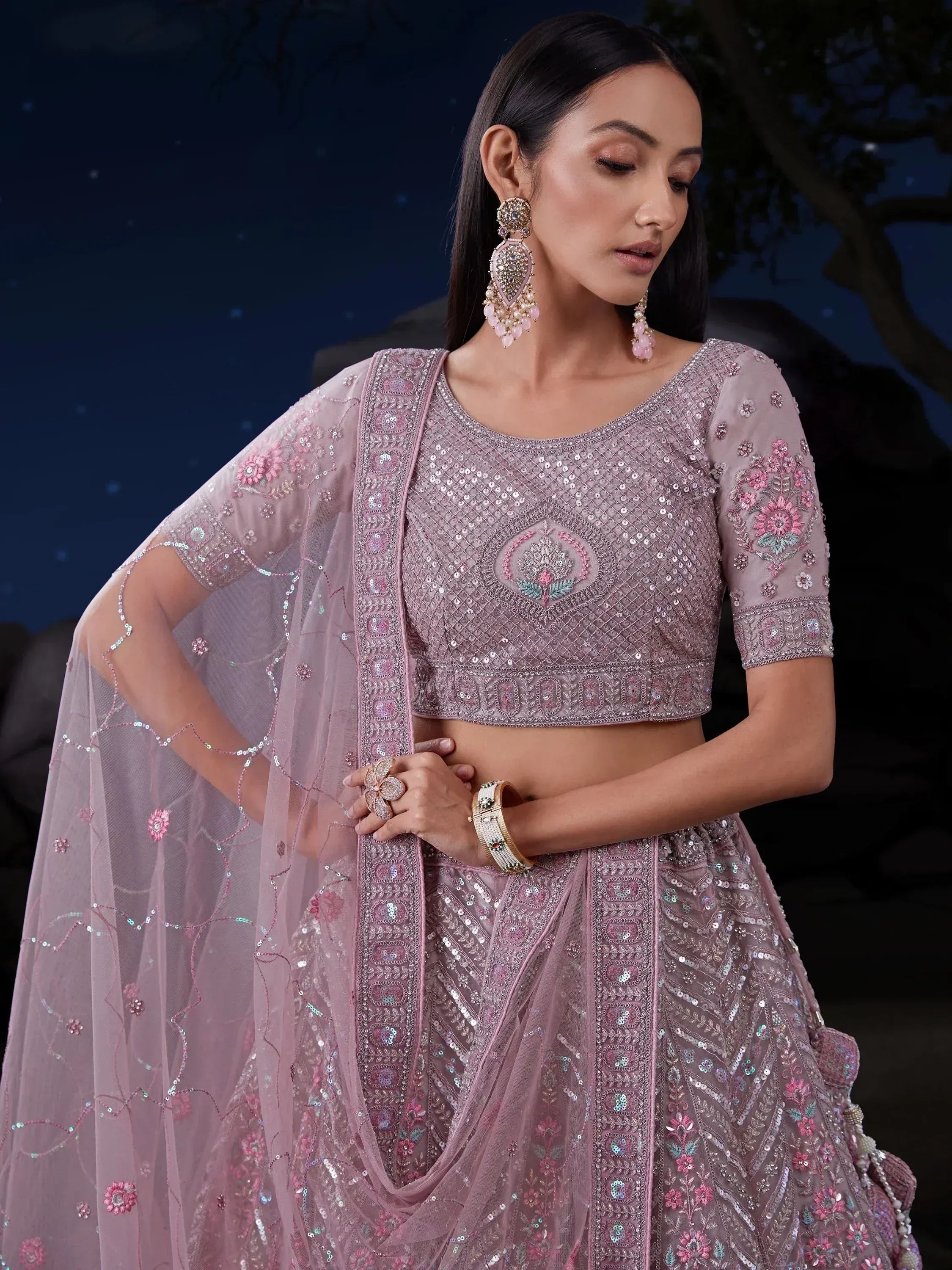 Elegant pink embroidered lehenga choli with sequins and floral motifs, perfect for Indian ethnic wear events.