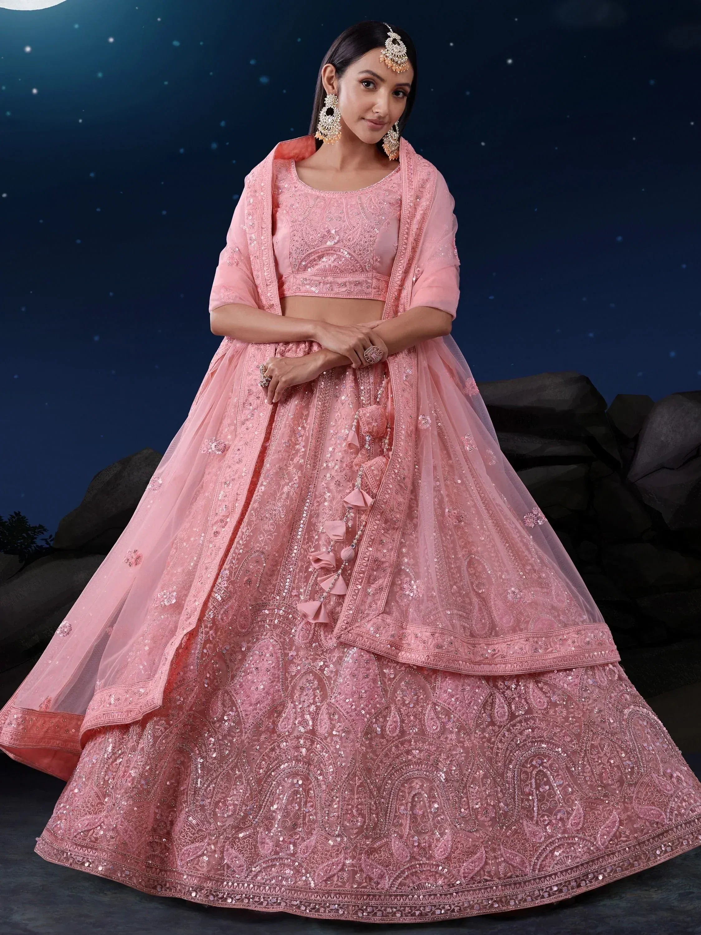 Pink embroidered lehenga choli with sequins and tassels, perfect for Indian weddings and festive occasions.