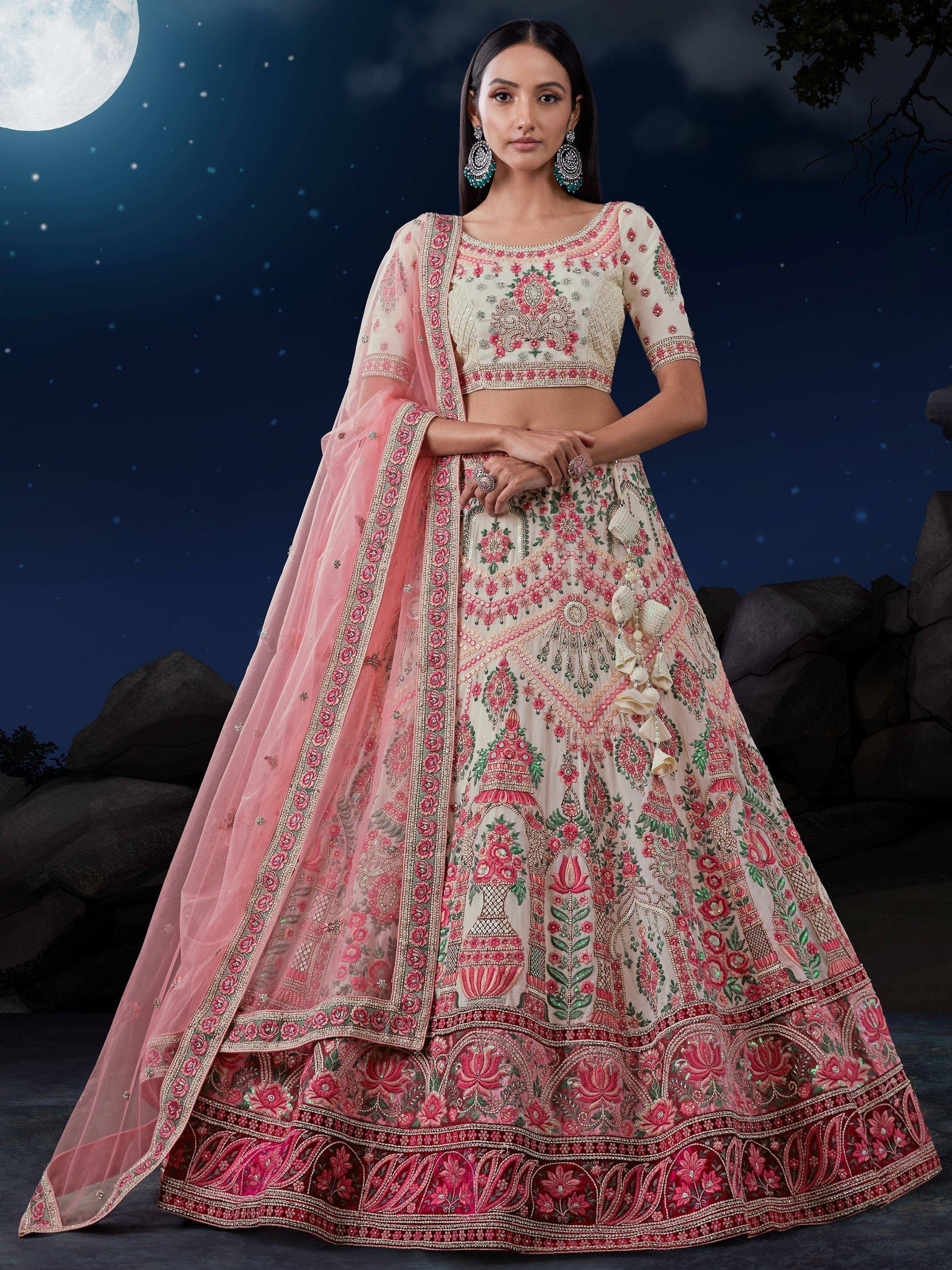 Elegant pink and cream embroidered lehenga choli with floral motifs, perfect for Indian weddings and festive occasions.