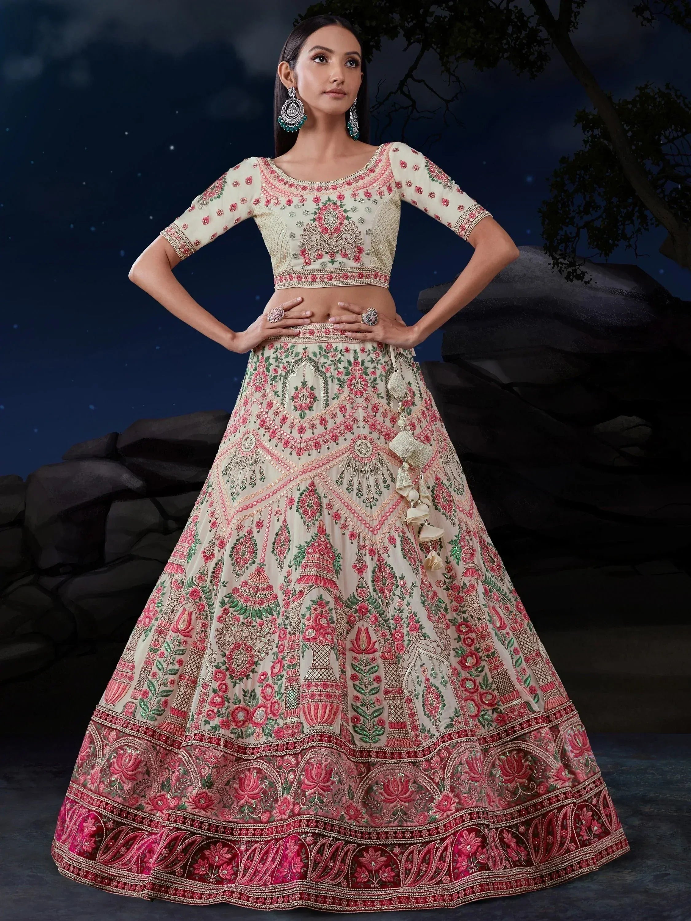 Elegant cream and pink embroidered lehenga choli with floral motifs, perfect for Indian weddings and festive occasions.