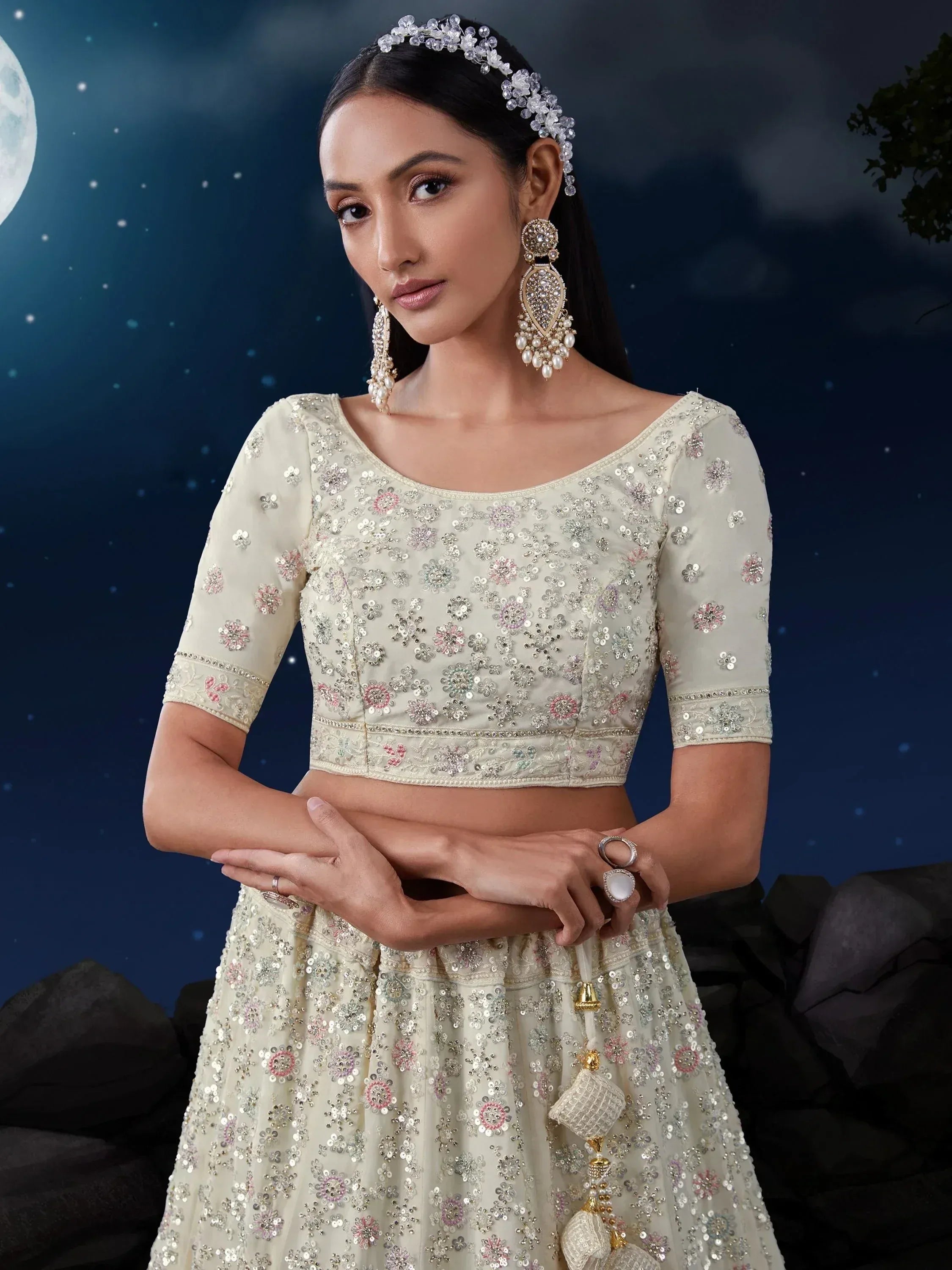 Elegant ivory lehenga choli with floral sequin embroidery, perfect for Indian weddings and festive occasions.
