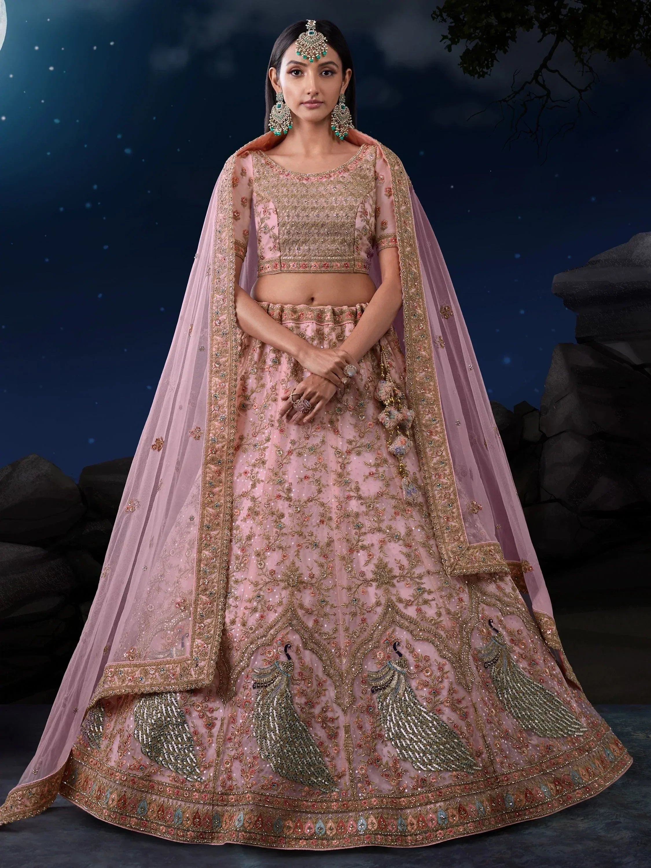 Pink embroidered lehenga choli with peacock motifs, perfect for Indian weddings and festive occasions.