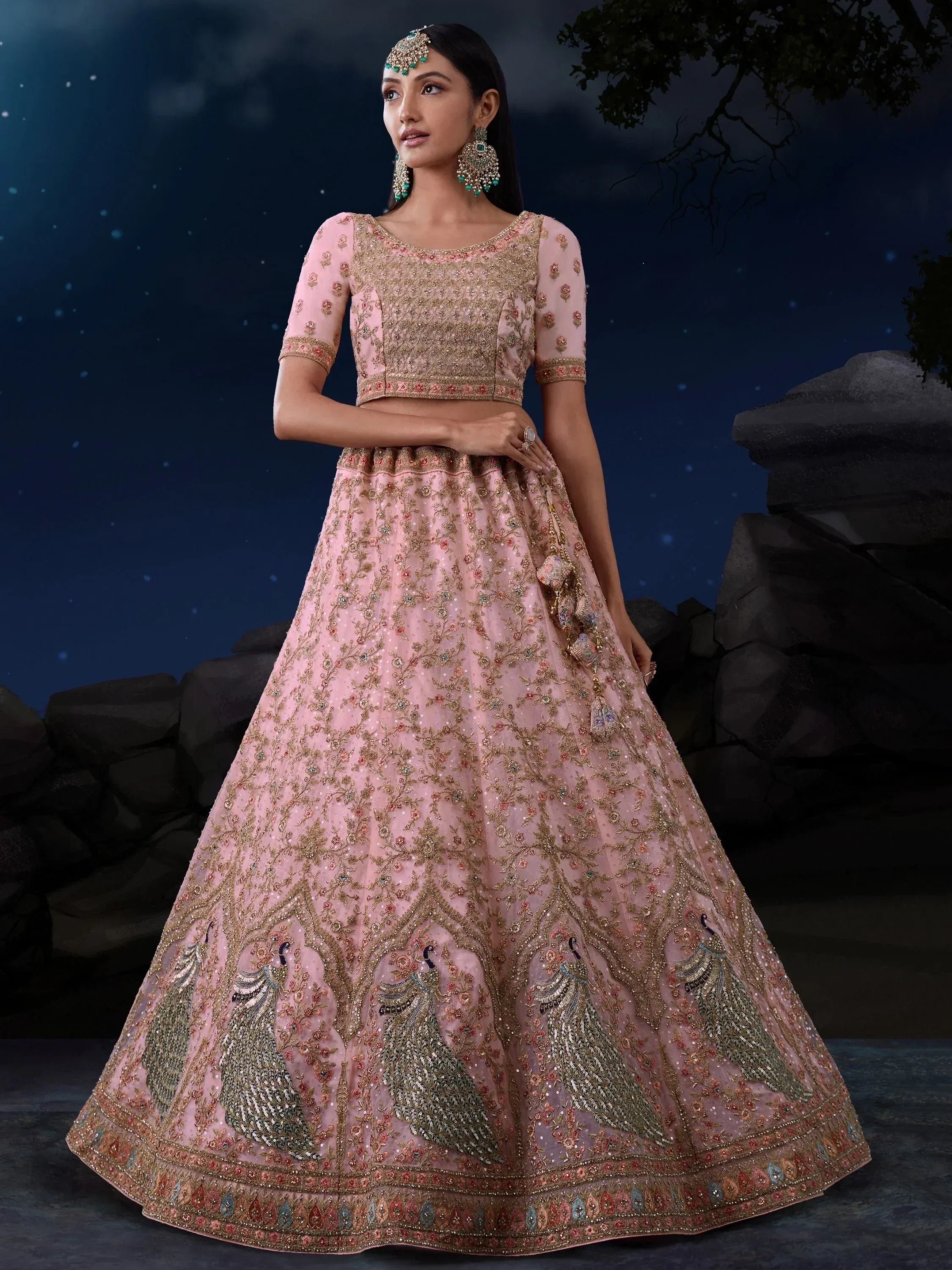 Pink embroidered lehenga choli with peacock motifs, perfect for Indian weddings and festive occasions.