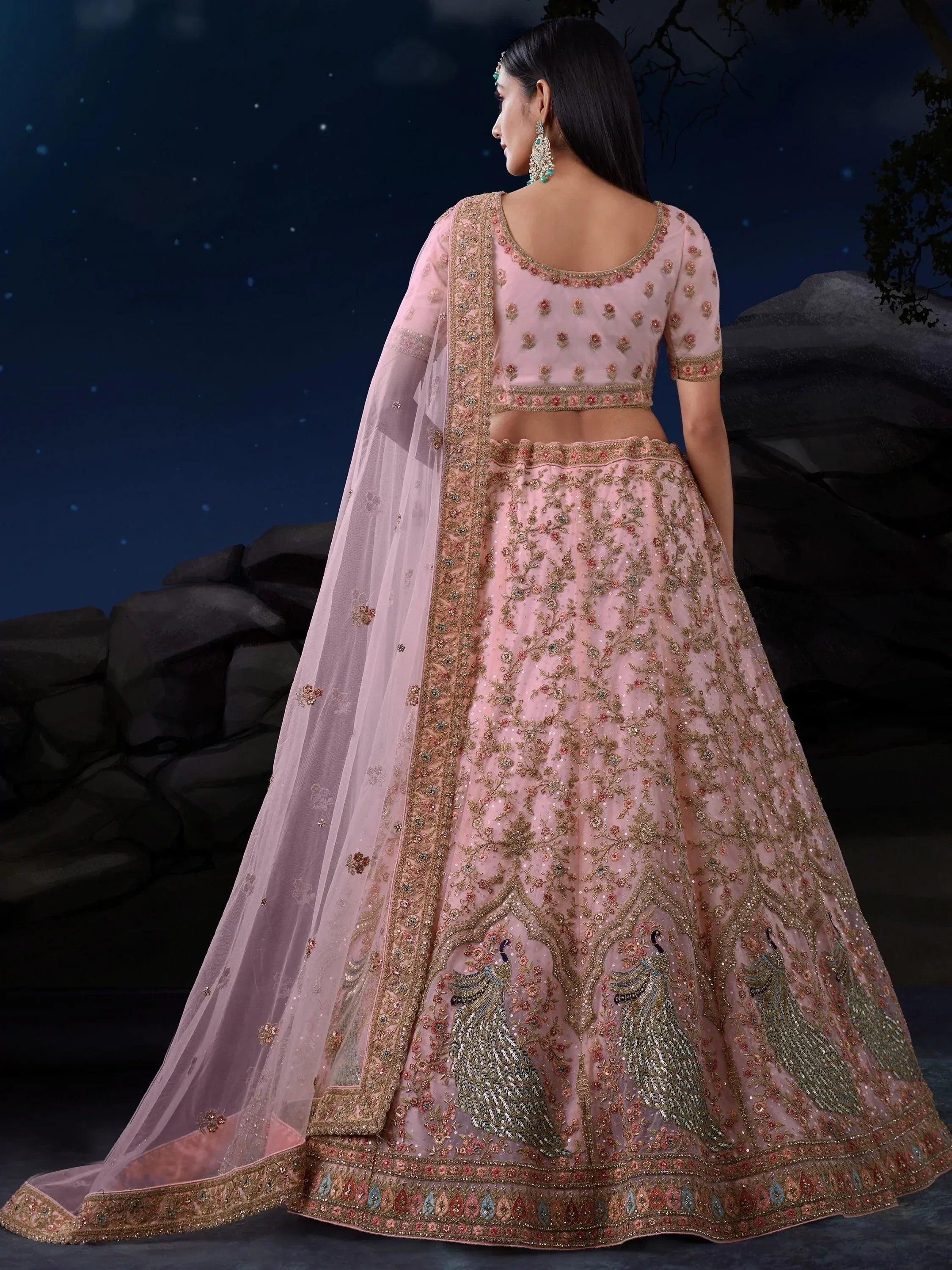 Pink embroidered lehenga choli with peacock motifs, perfect for Indian weddings and festive occasions.