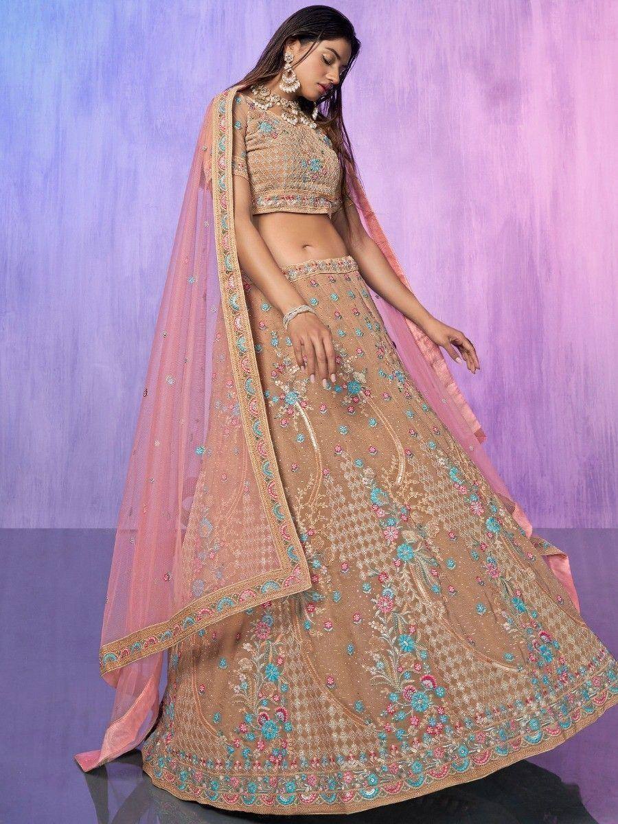 Elegant beige lehenga choli with floral embroidery and pink dupatta, perfect for Indian ethnic occasions.