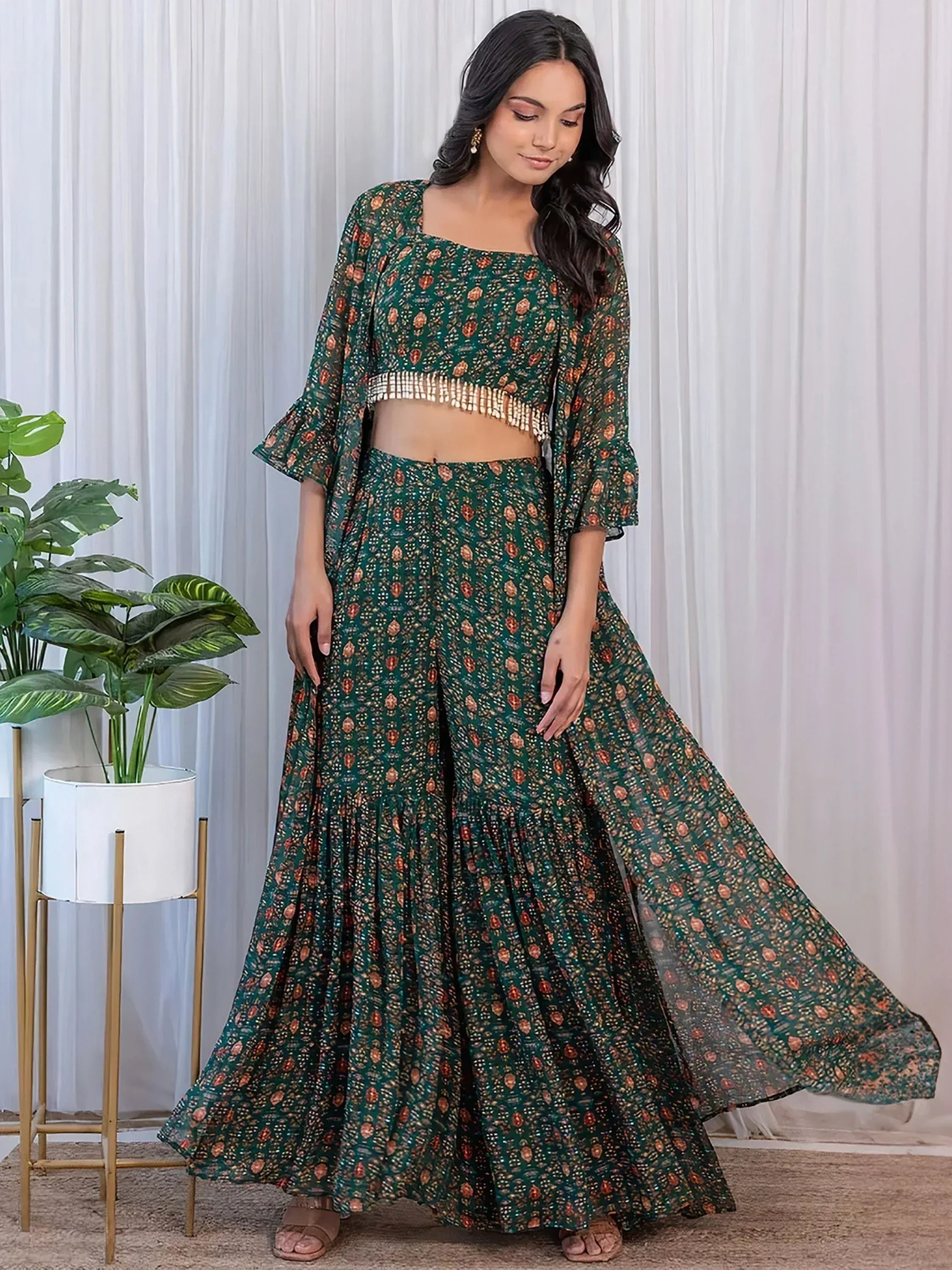 Green printed ethnic palazzo set with flared top and ruffled hem, perfect for Indian occasions