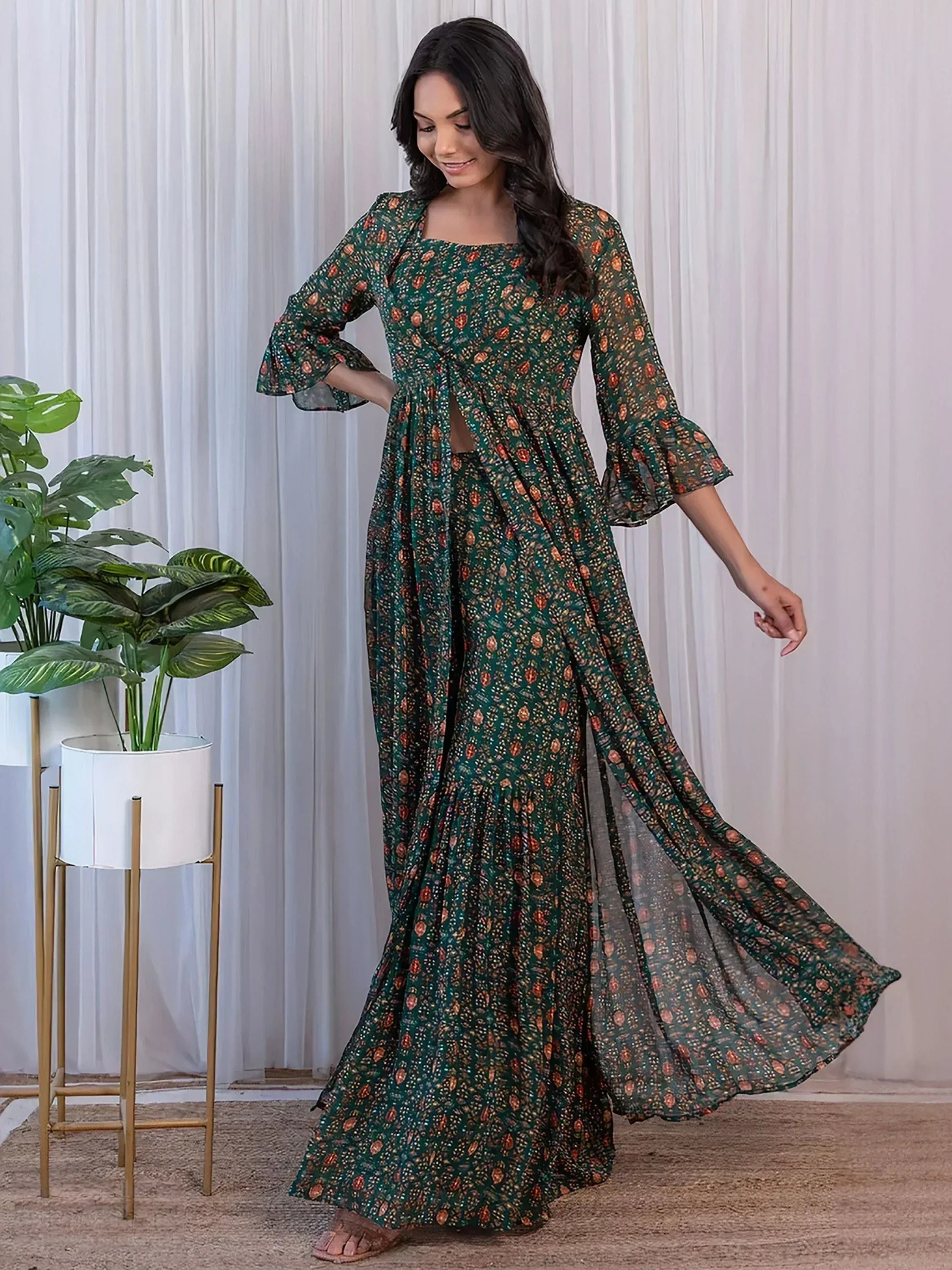 Green printed ethnic gown with flared sleeves and side slit, perfect for Indian occasions