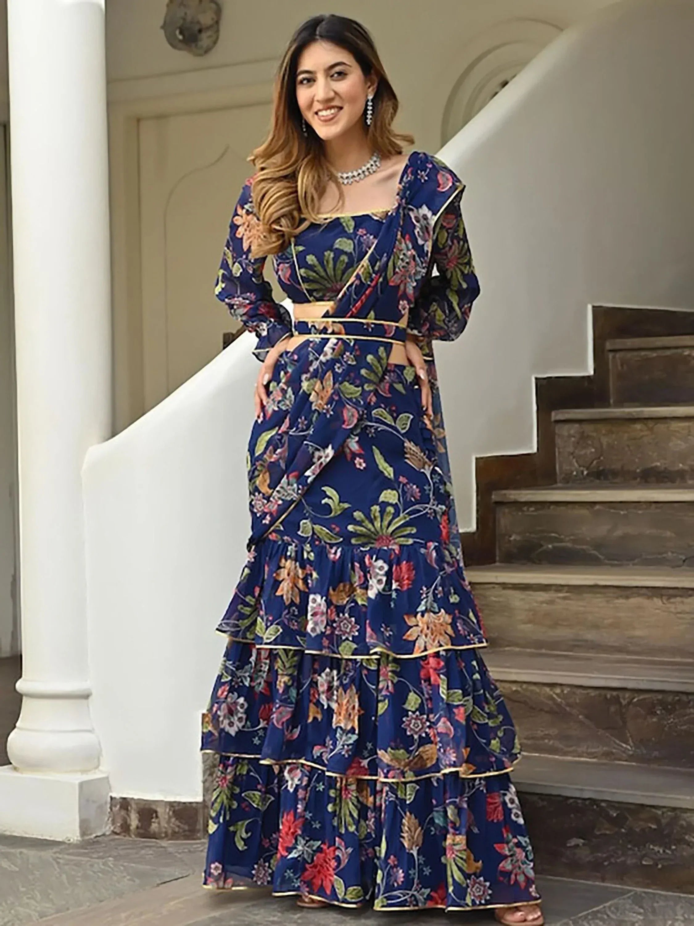 Blue floral printed lehenga choli with ruffled skirt and gold trim, perfect for Indian ethnic occasions