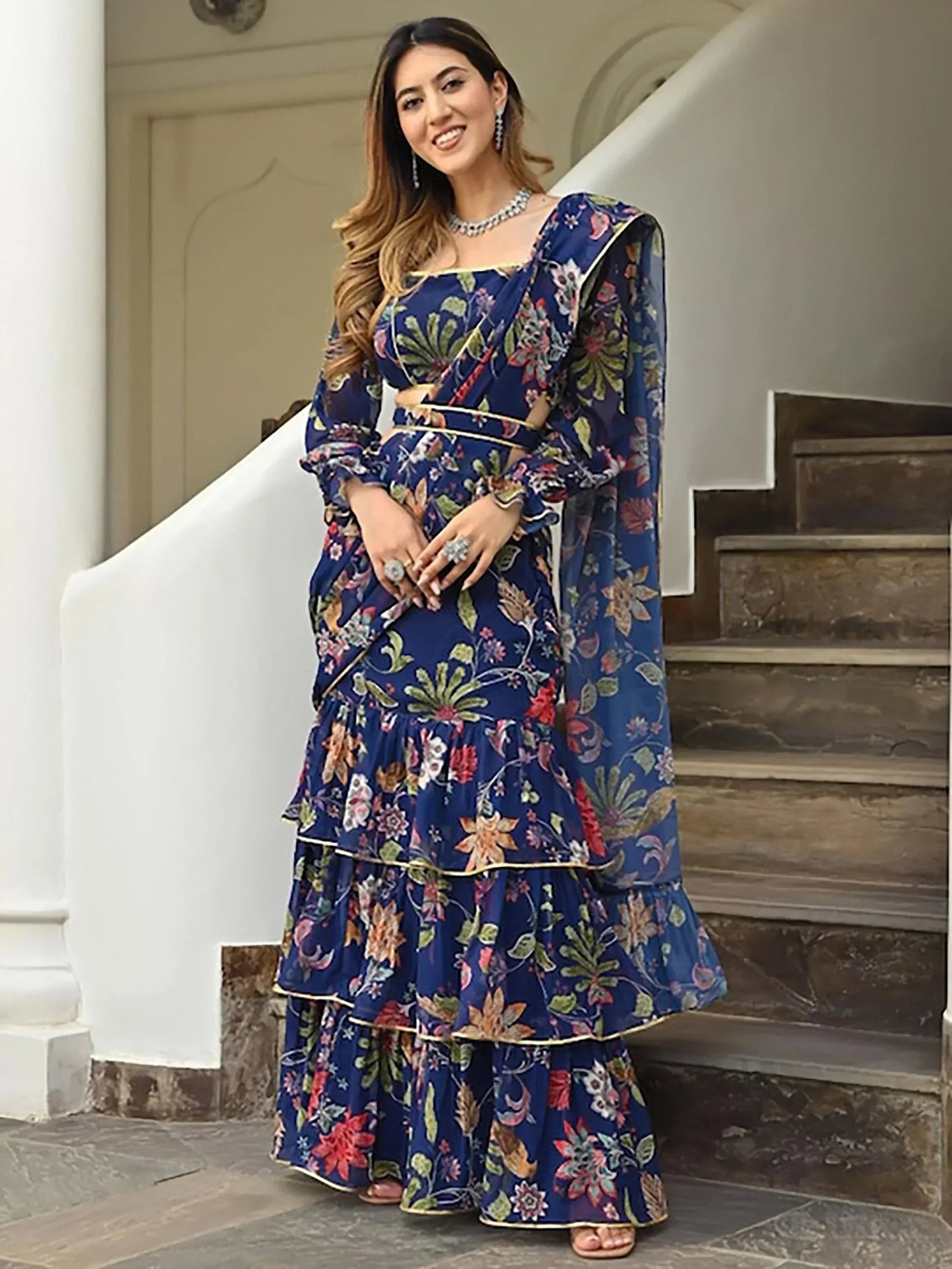 Blue floral printed lehenga choli with ruffled layers and gold trim, perfect for Indian ethnic occasions