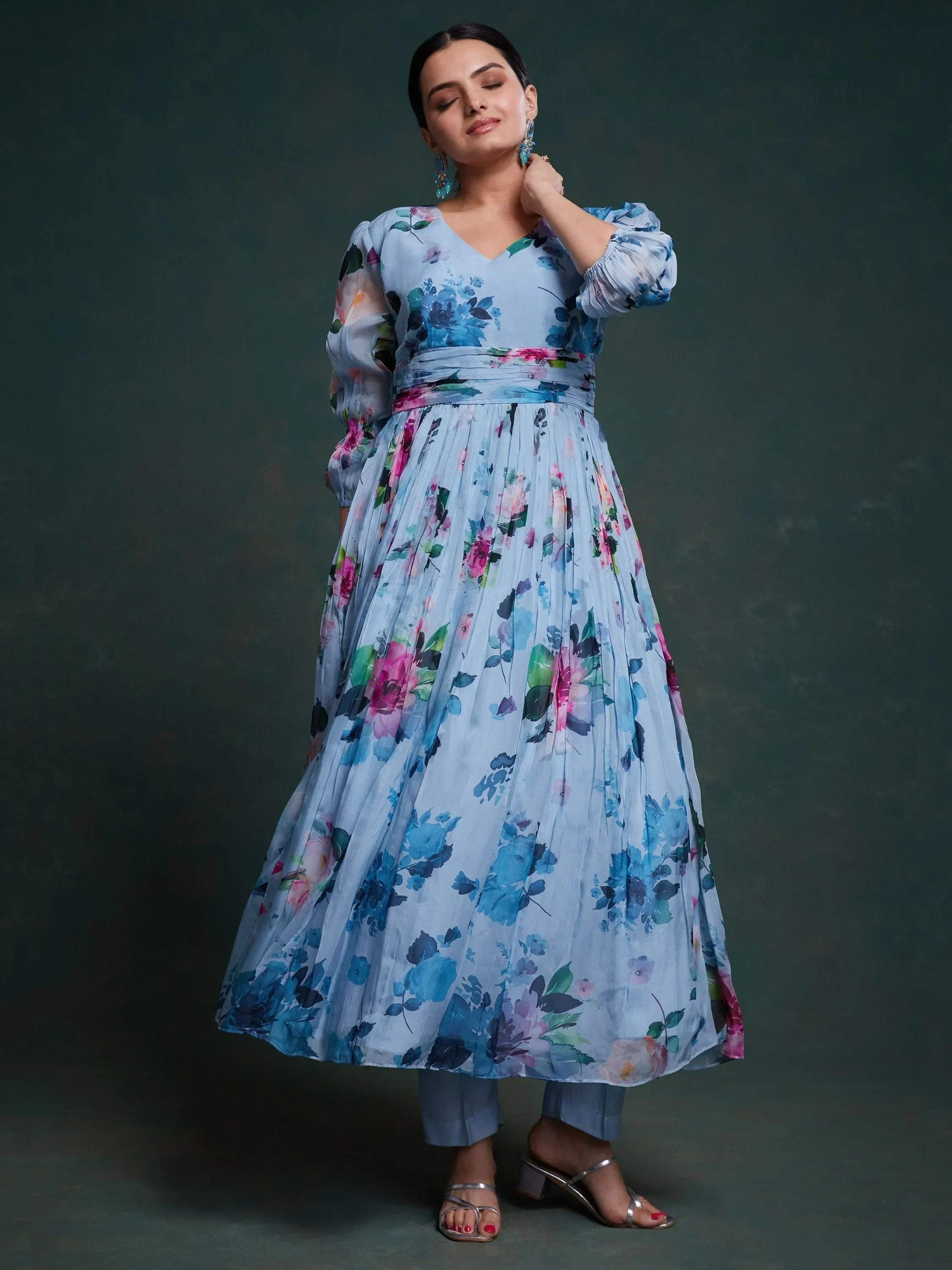 Woman in blue floral printed ethnic gown with long sleeves and silver heels