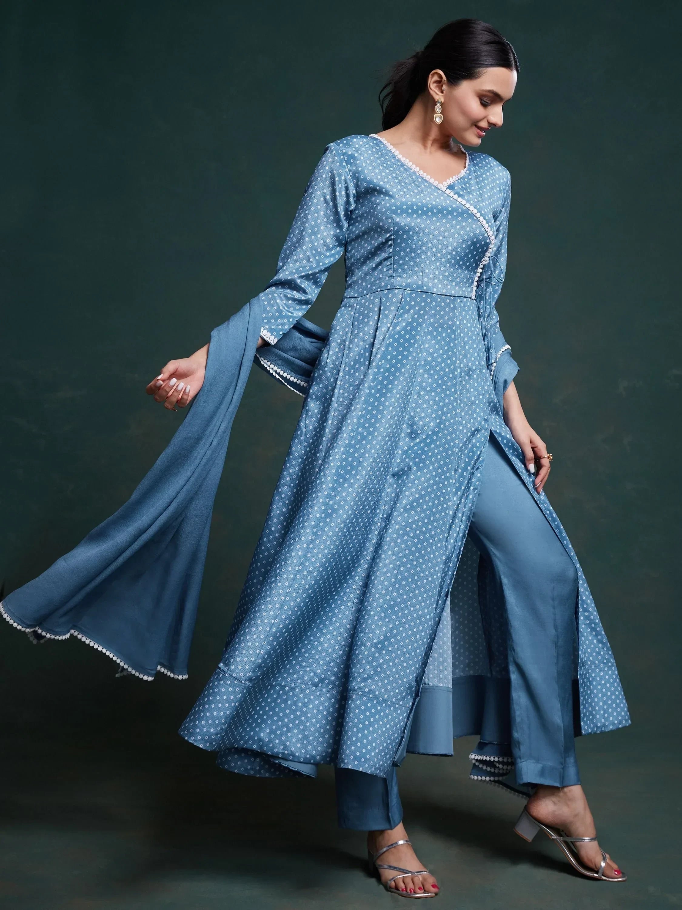 Woman wearing a blue ethnic Anarkali suit with dupatta and matching pants, elegant look