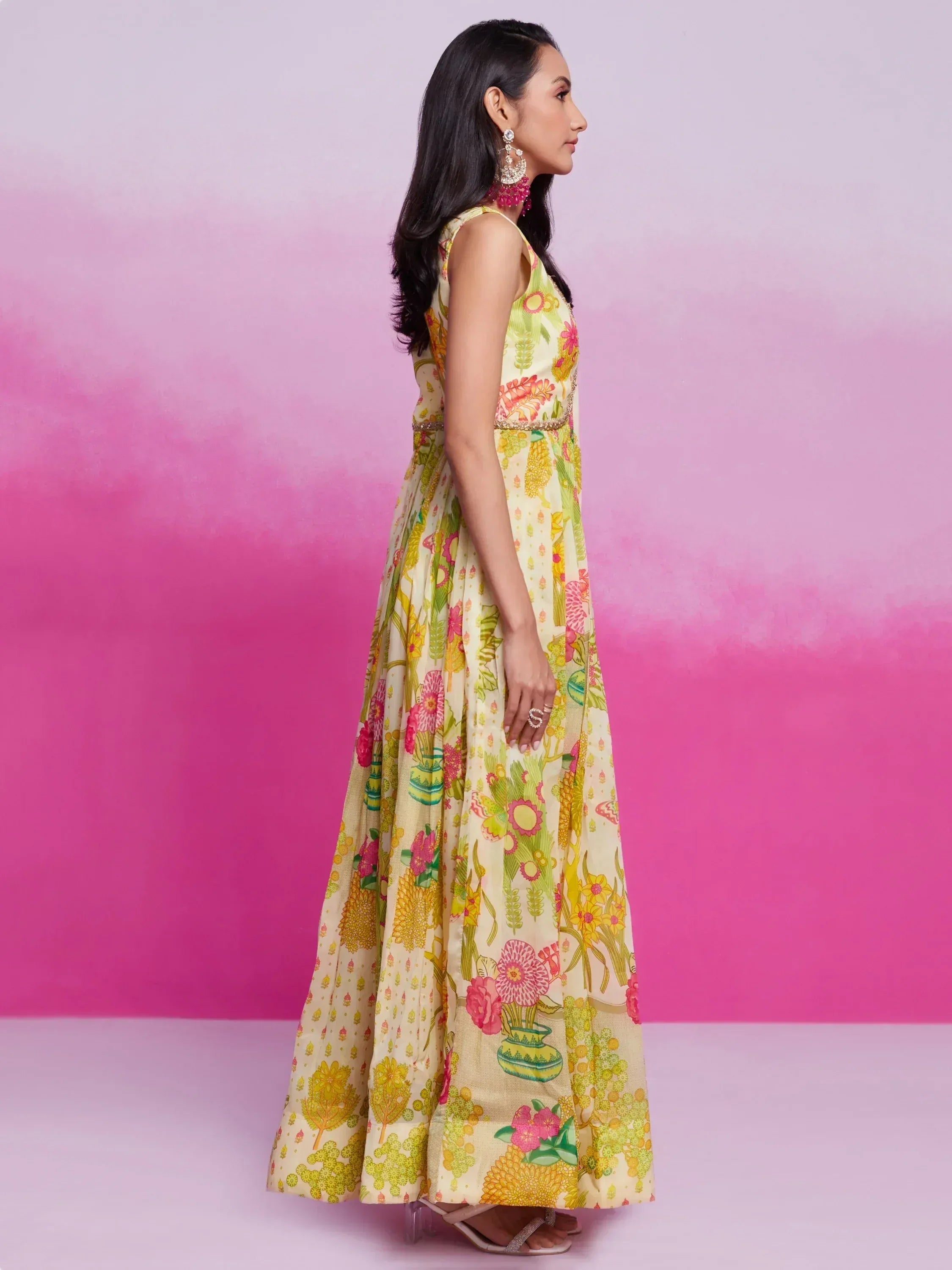 Woman in floral print ethnic gown with vibrant colors, perfect for Indian occasions and festive wear.