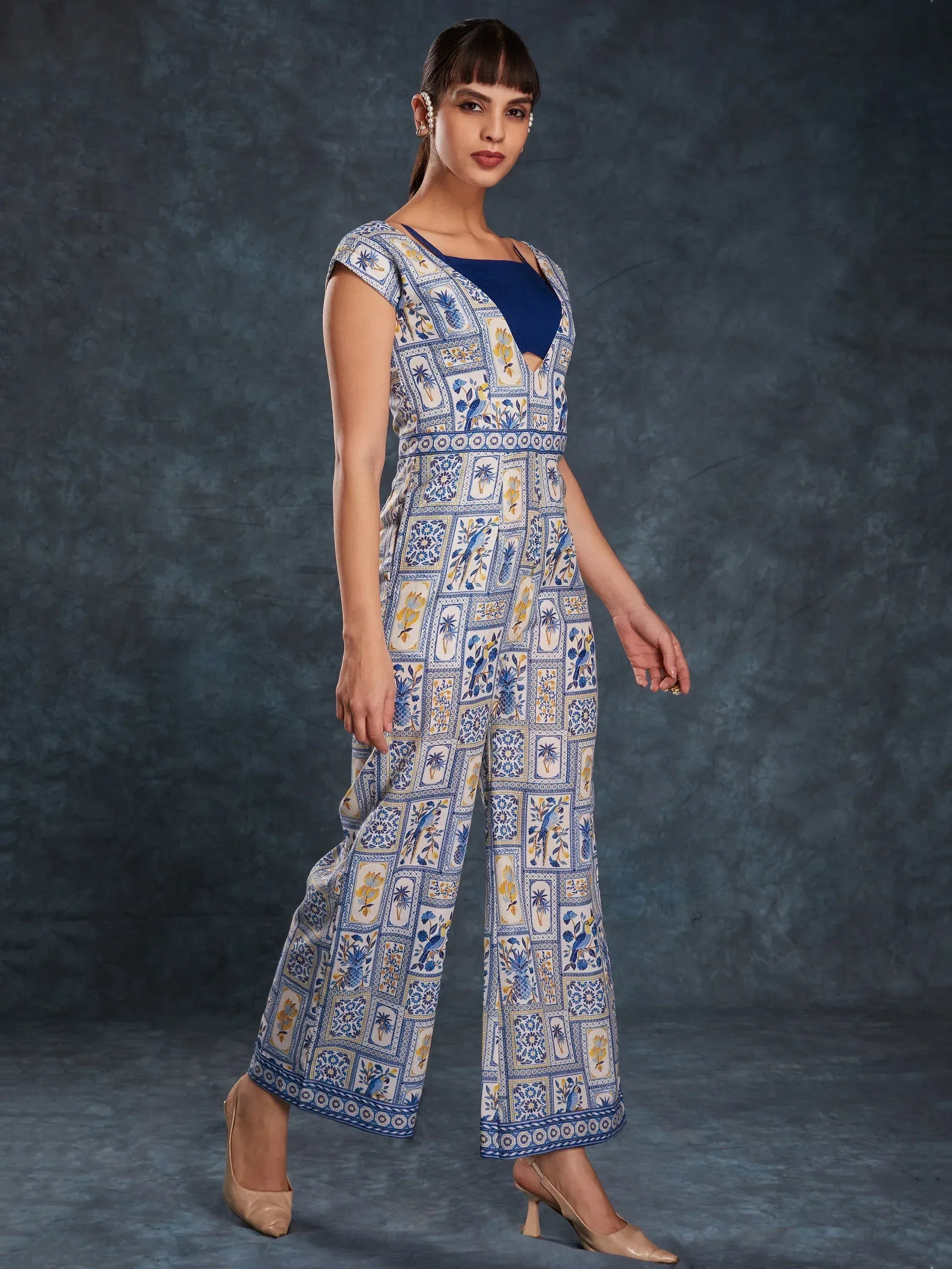 Blue and white printed ethnic jumpsuit with wide legs and floral patterns, styled for modern Indian wear.