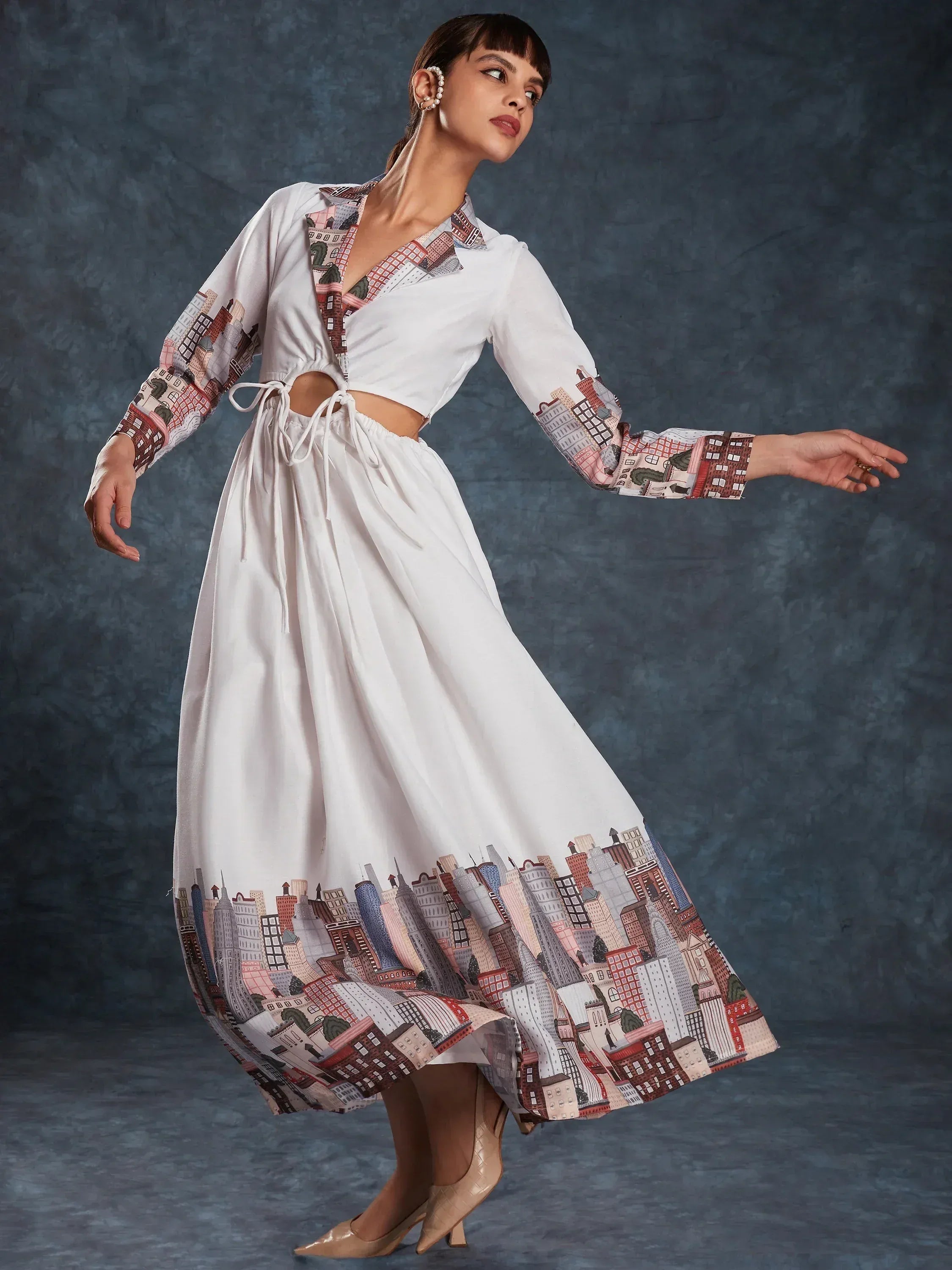 White ethnic gown with city print, long sleeves, and side cutouts for modern Indian wear