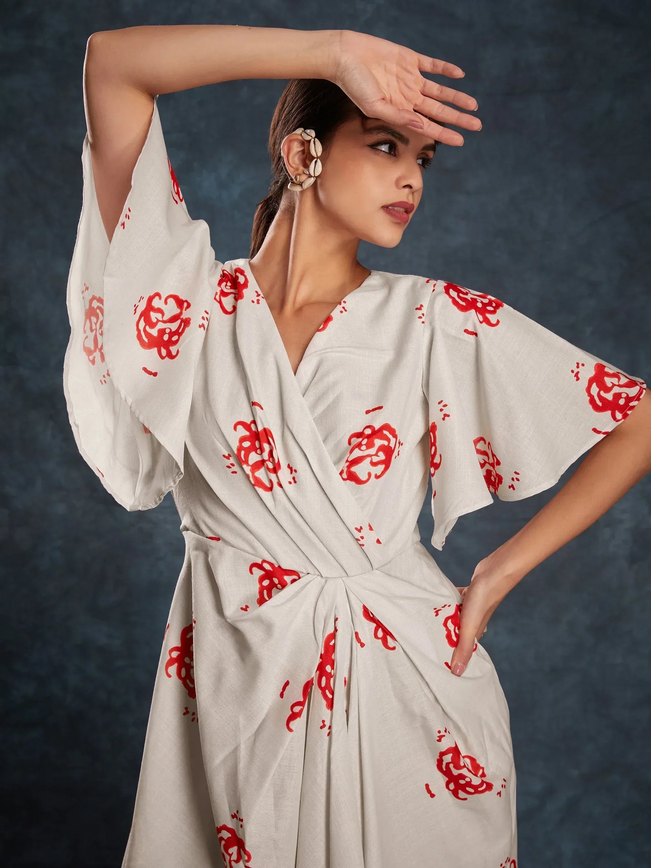White ethnic gown with red floral print, V-neck, and flared sleeves for women