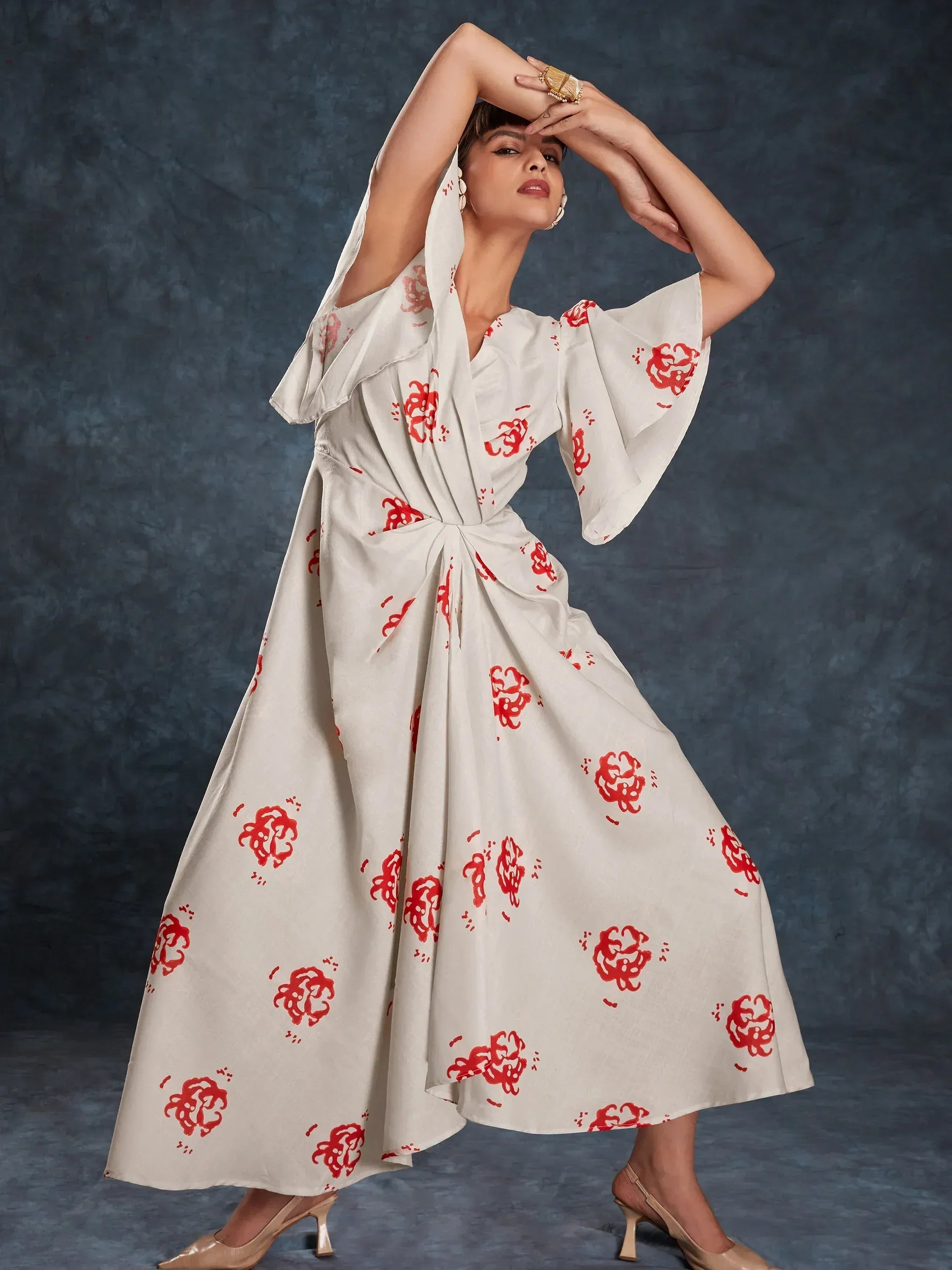 White ethnic gown with red floral print, flared sleeves, and knot waist, styled for Indian occasions