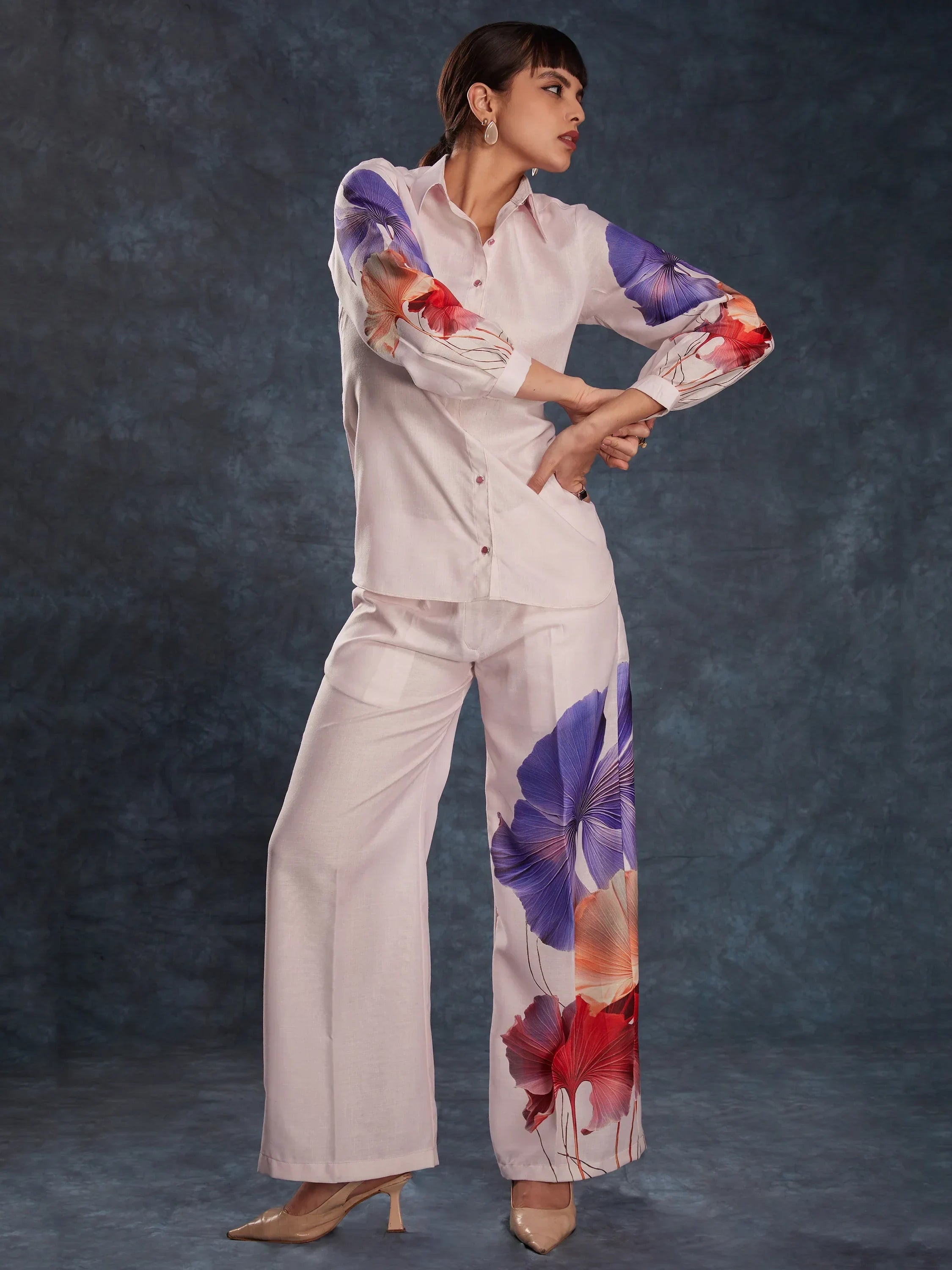 Woman wearing pastel co-ord set with bold floral prints on sleeves and pants, fashion outfit